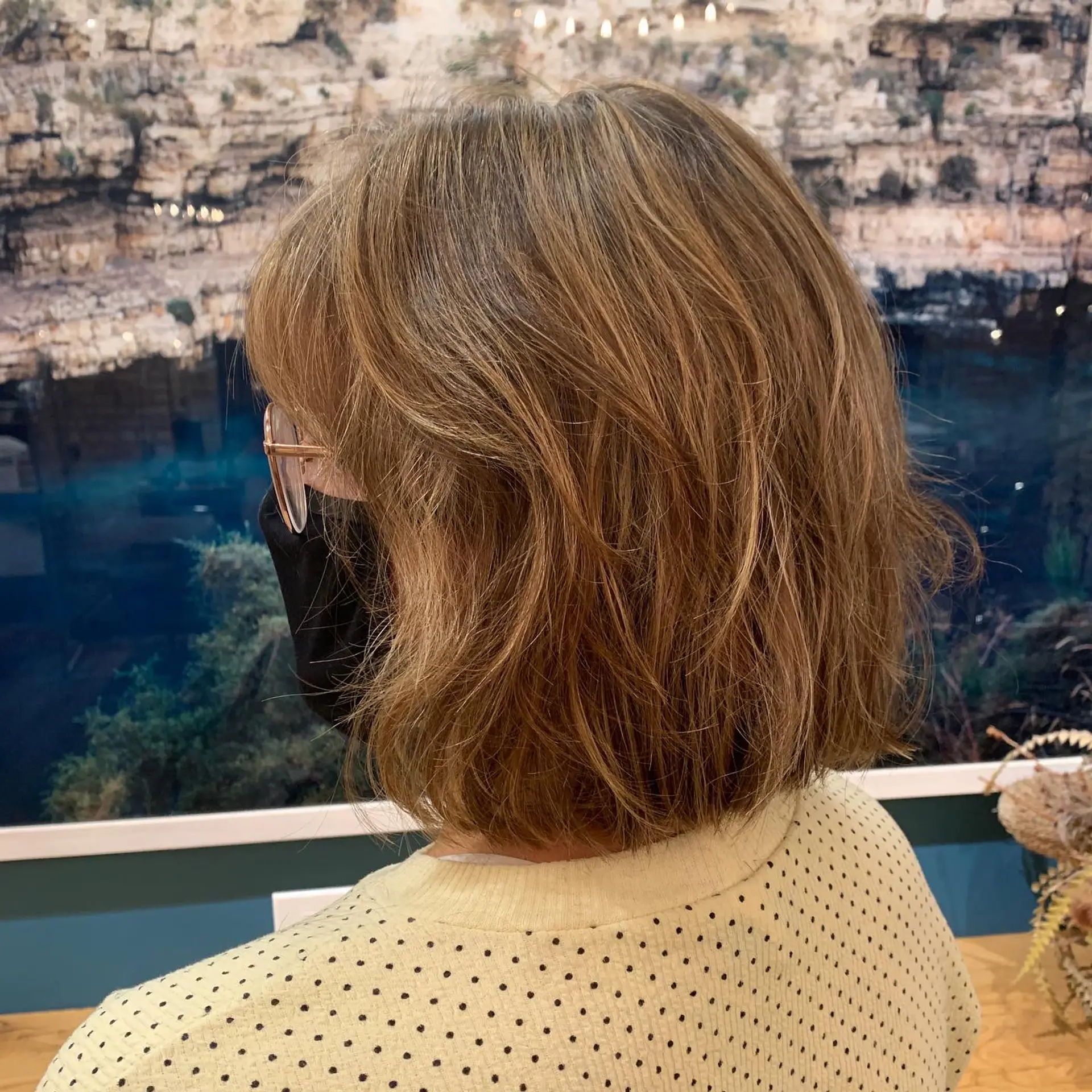 A trendy medium-length, layered bob with baby bangs and a textured finish. 3