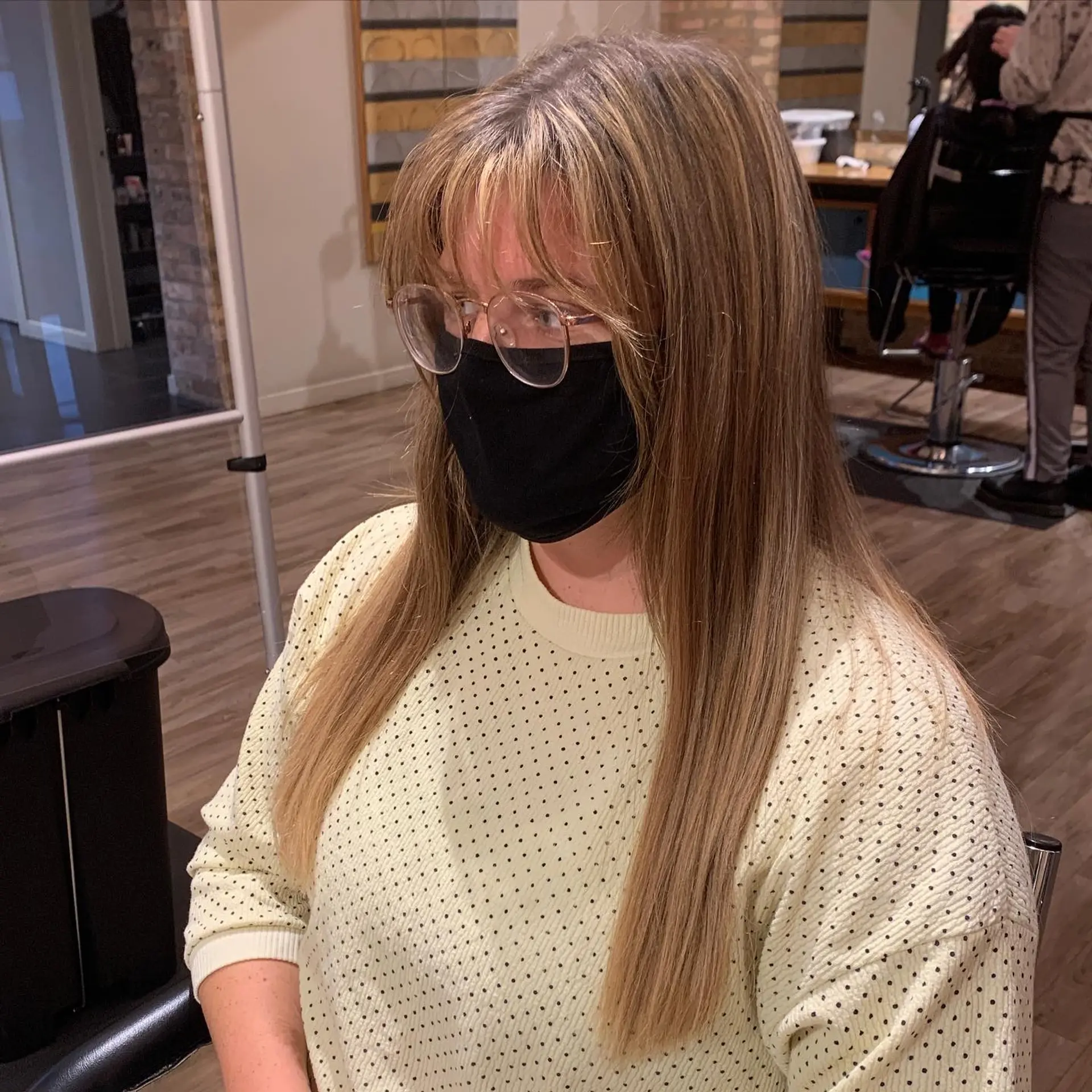 A trendy medium-length, layered bob with baby bangs and a textured finish. 4