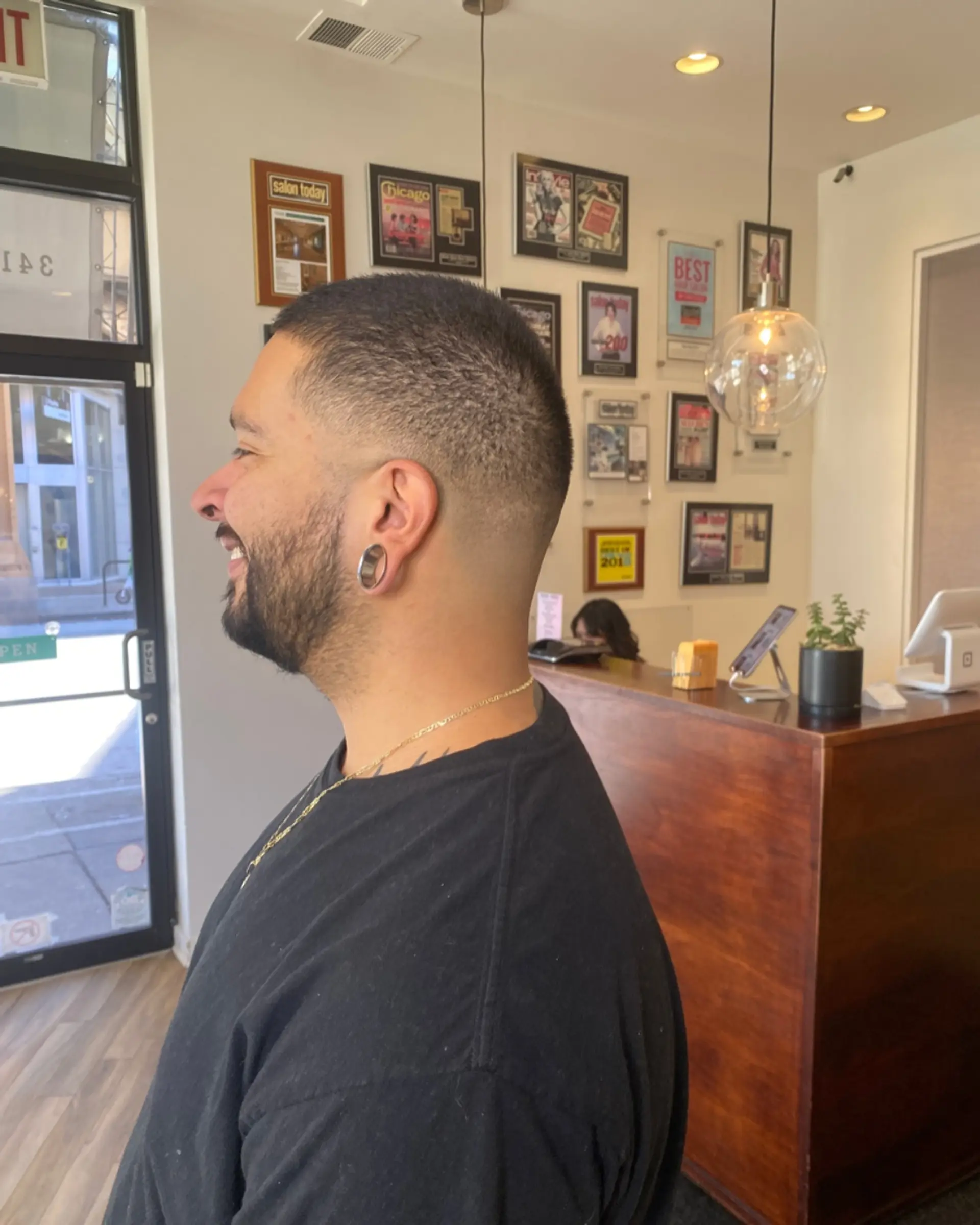 A short buzz cut with a clean and gradual taper fade. 1