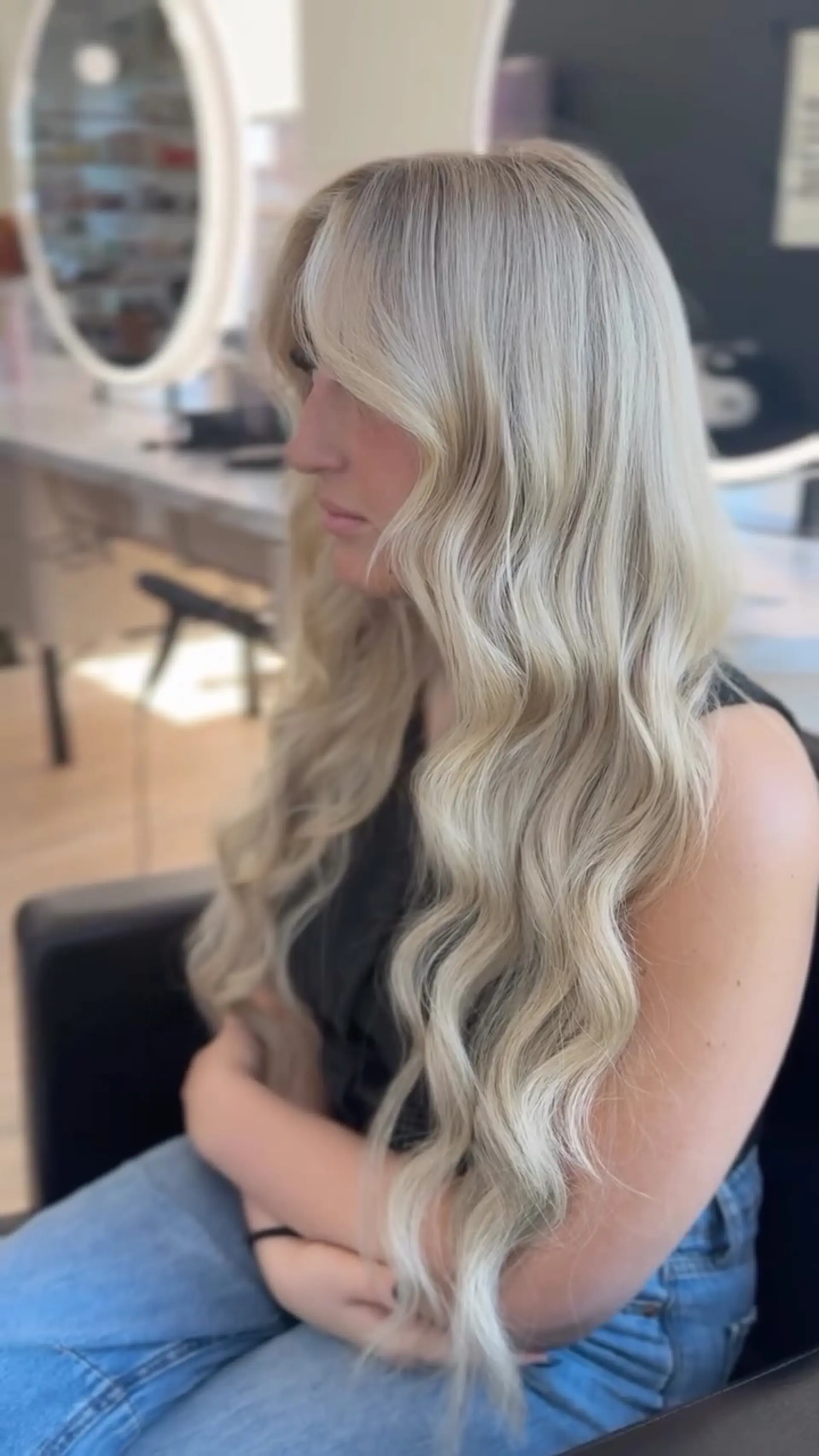 Very long, luminous ash platinum blonde hair styled with loose cascading waves and soft face-framing layers. 1