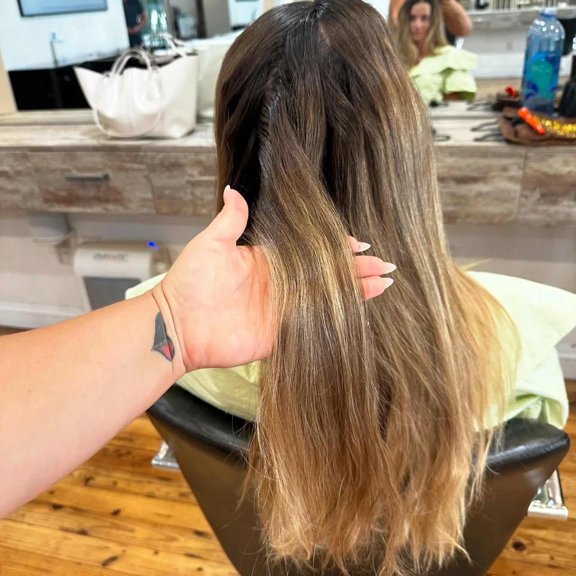 A gorgeous long wavy hairstyle with a bronde balayage, expertly blended for a seamless transition from brunette to blonde. 3