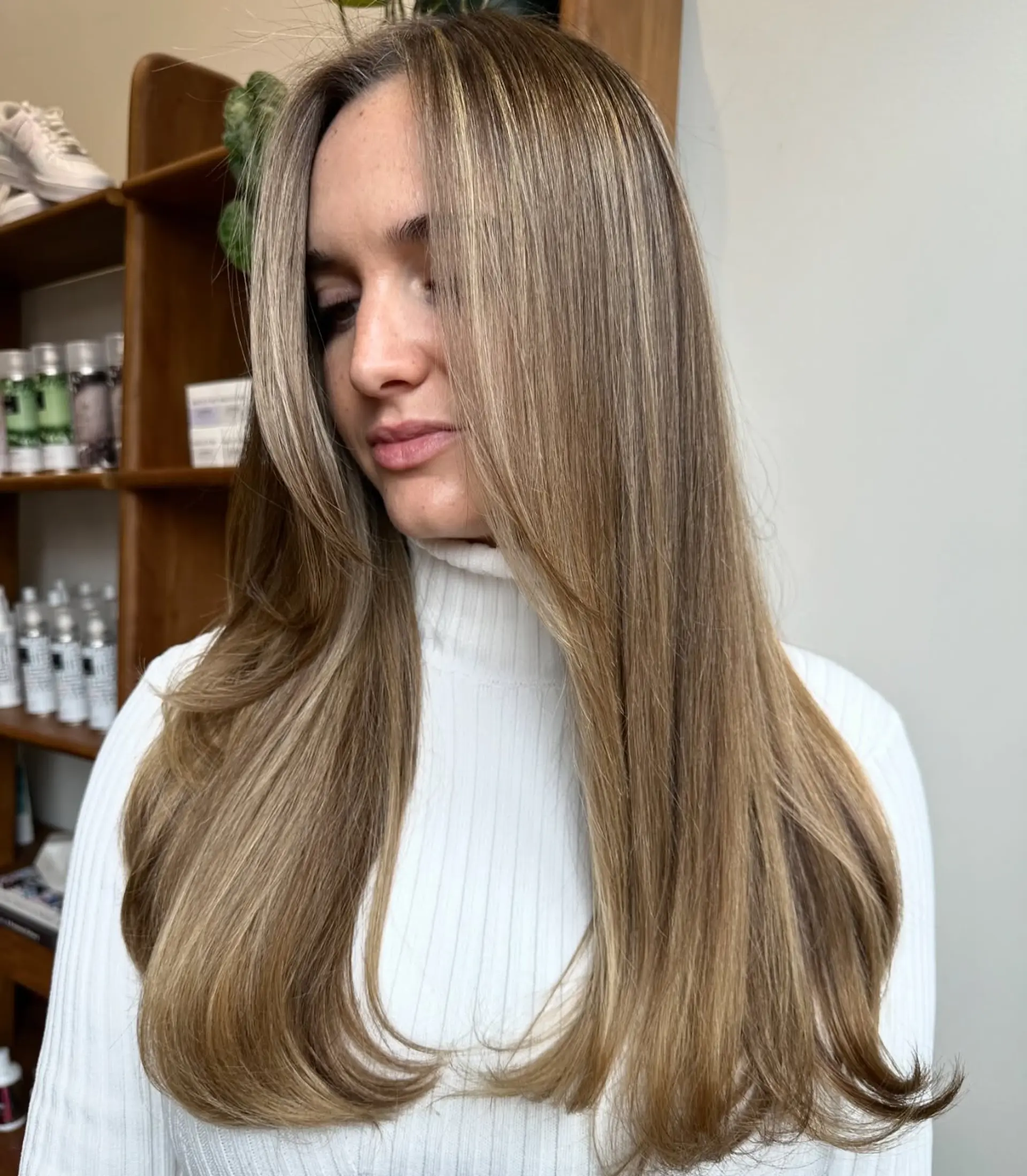 A long, layered hairstyle with face-framing layers and a subtle balayage. 1