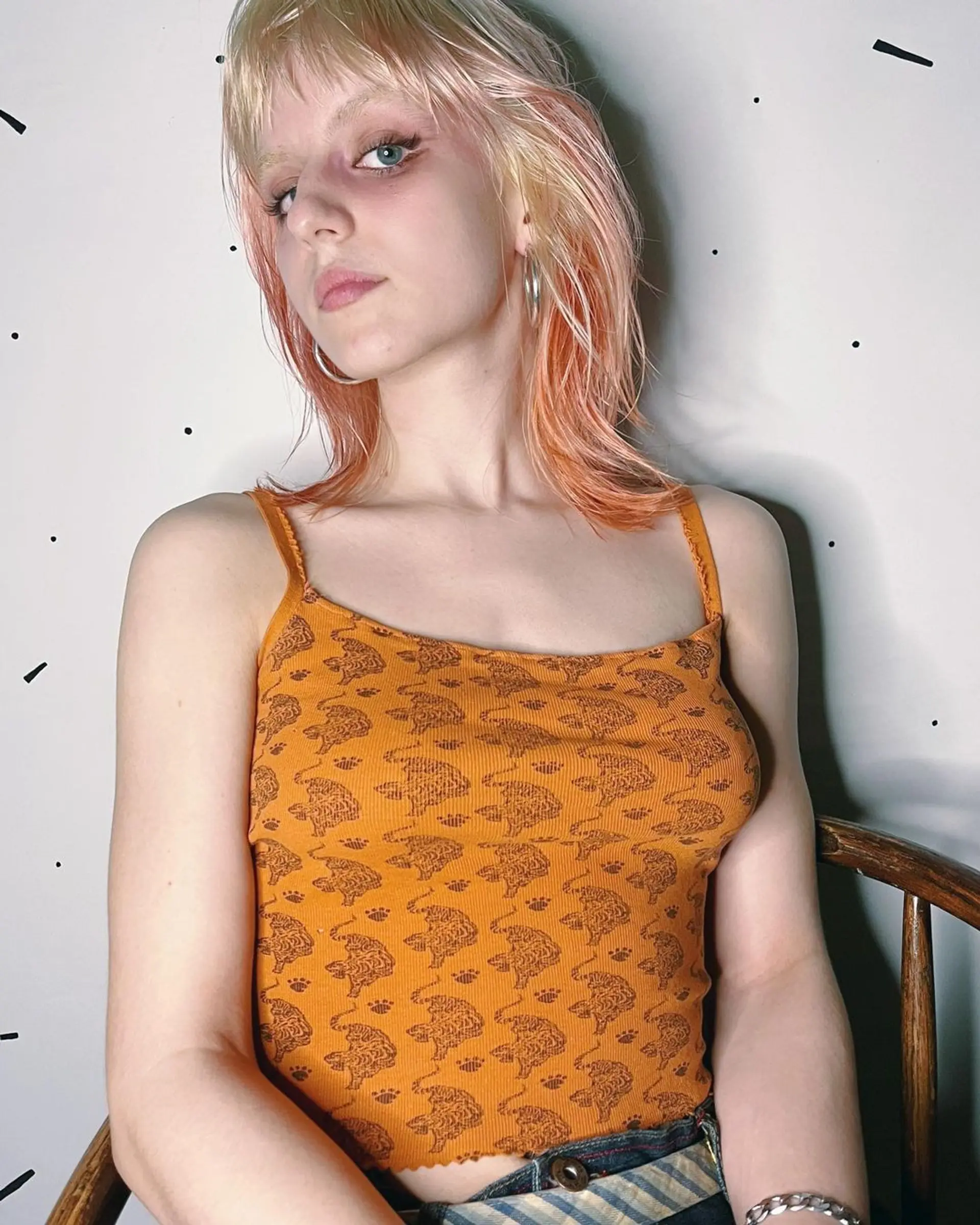 Medium length, wavy hair with fringe bangs, layered and triple-tone in blonde and peach and orange hues. 1