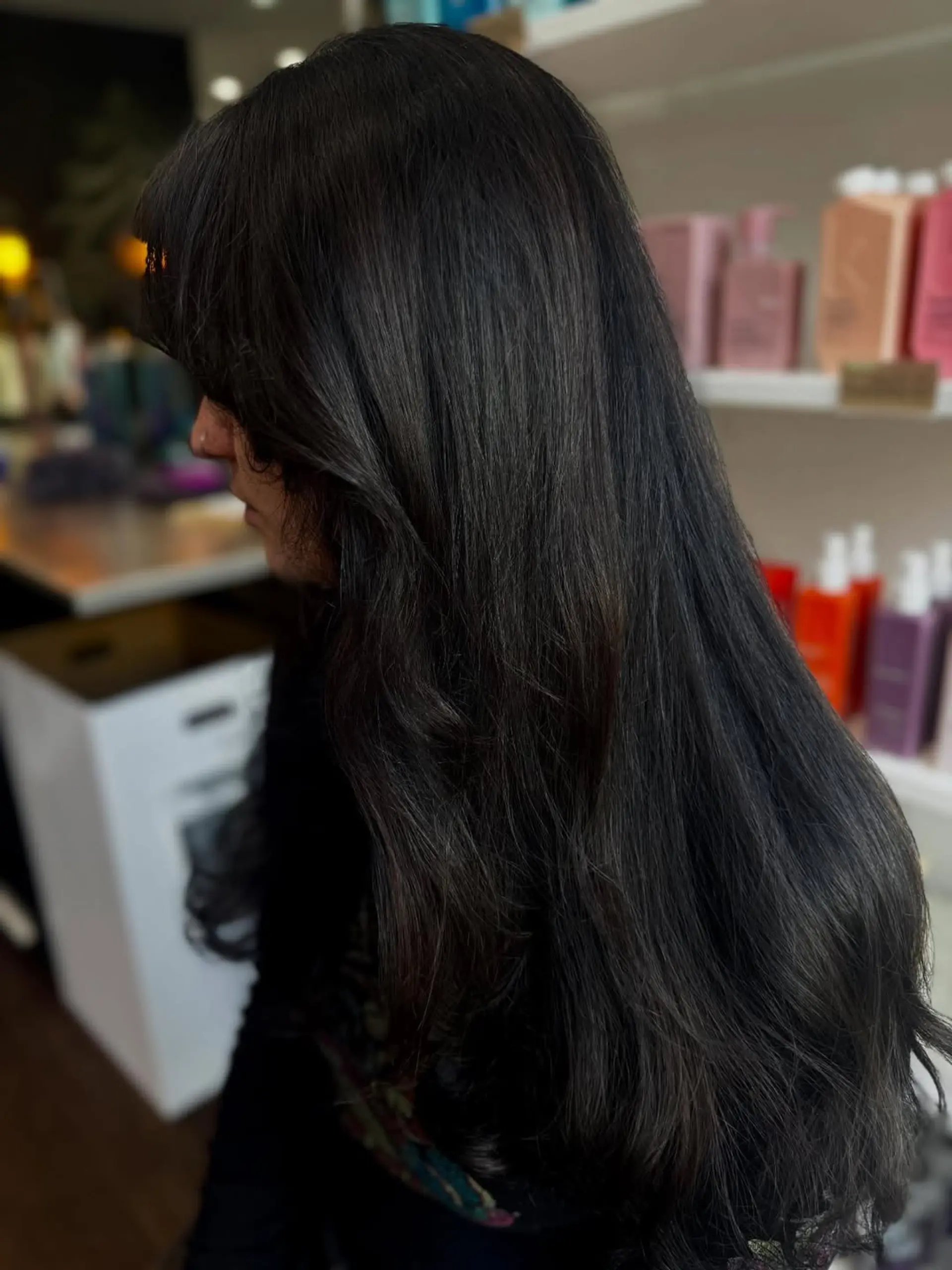A beautiful long hairstyle with soft layers that add movement and volume, complemented by face-framing bangs for a flattering look. The ends have a gentle wave, creating a polished yet natural appearance. 1