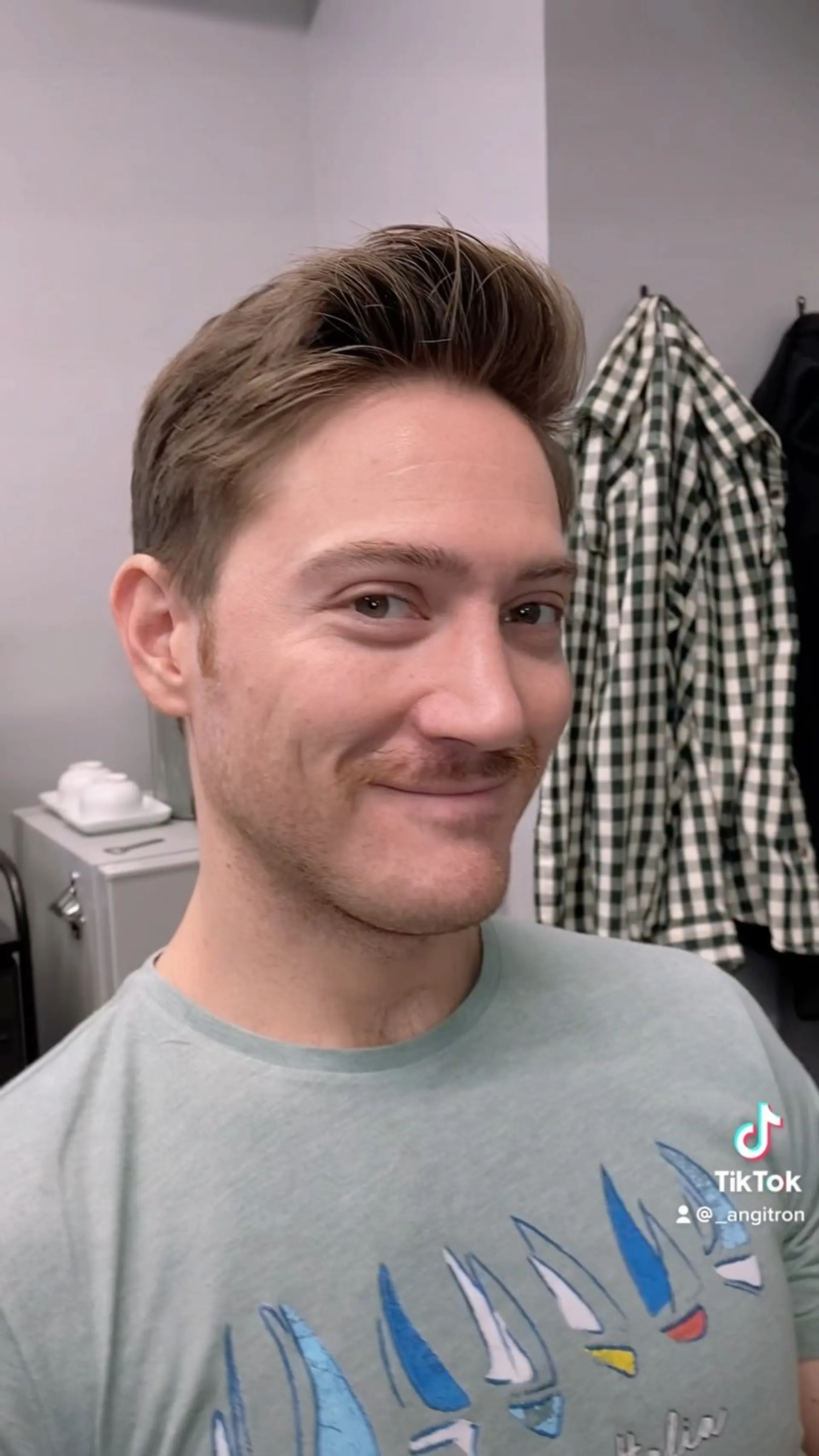 A tapered short haircut styled upward with soft volume and natural texture in front. 1