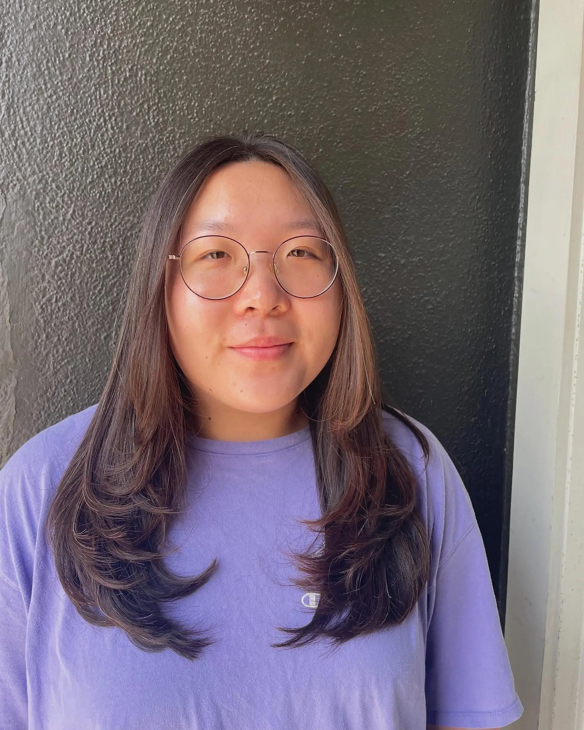 Long, layered hairstyle with face-framing auburn highlights. 1