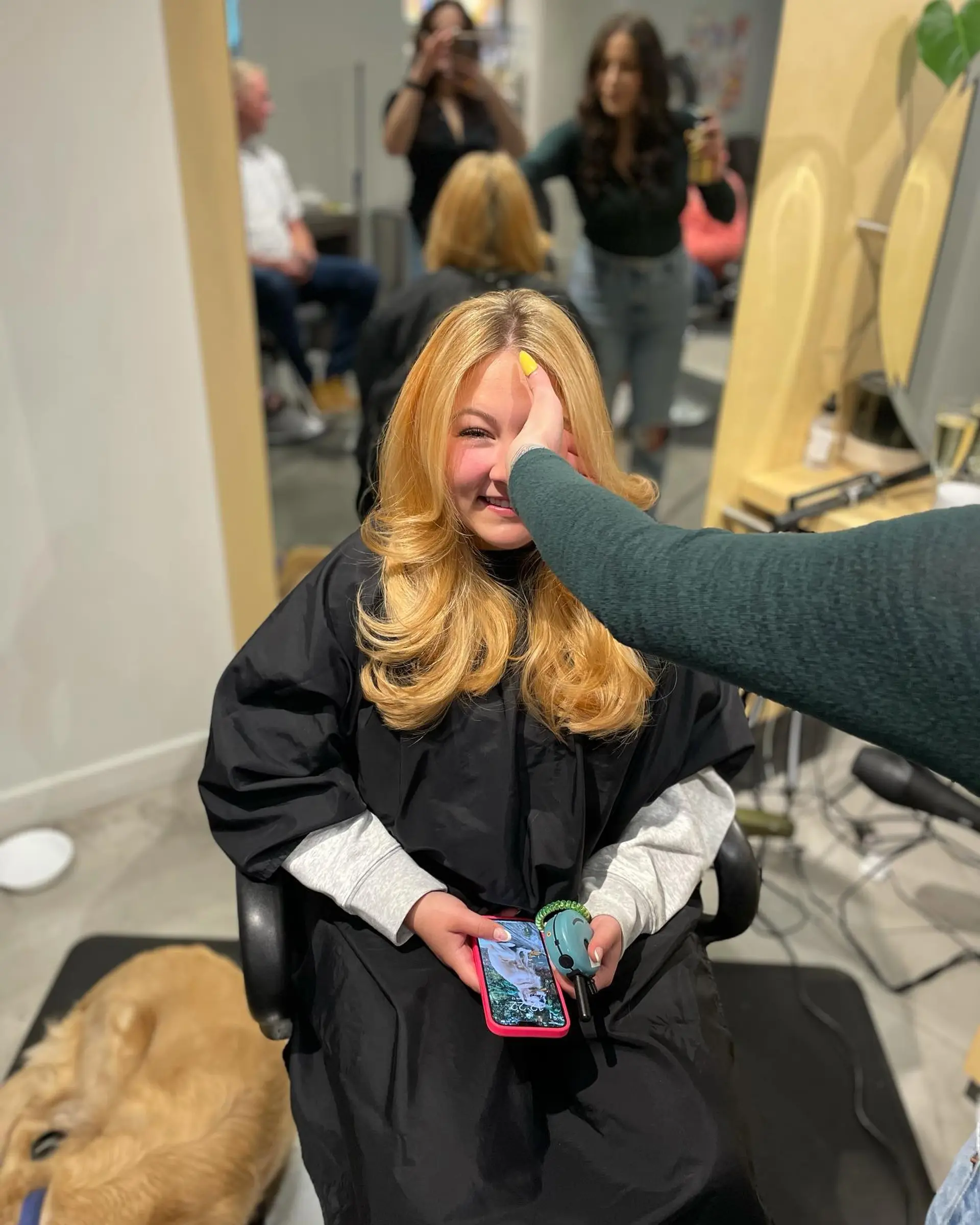 A medium-length golden blonde blowout featuring bouncy curled ends, soft face-framing layers, and high-volume roots. 1