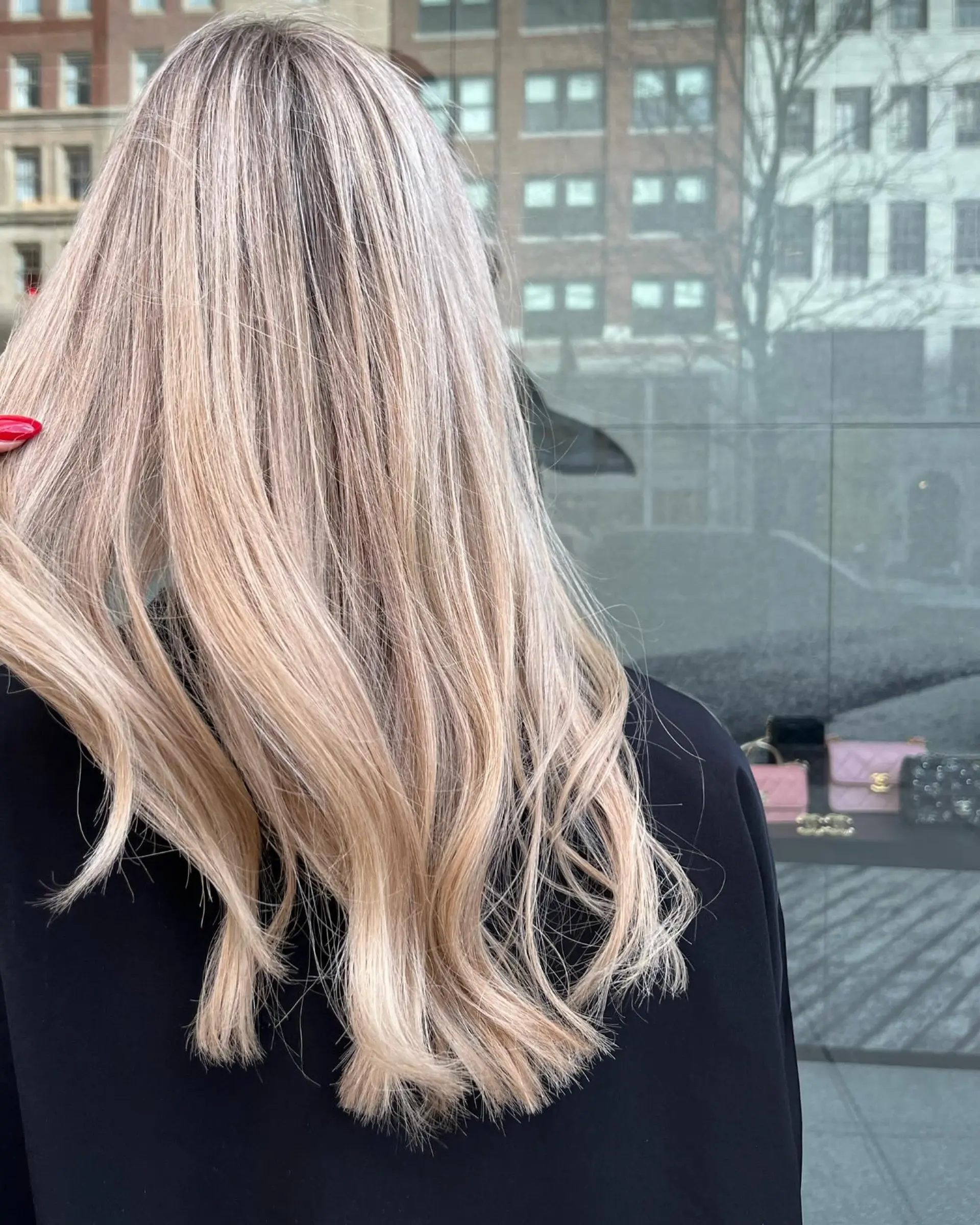Long beige-blonde hair with comprehensive full highlights styled into loose, effortless waves. 1