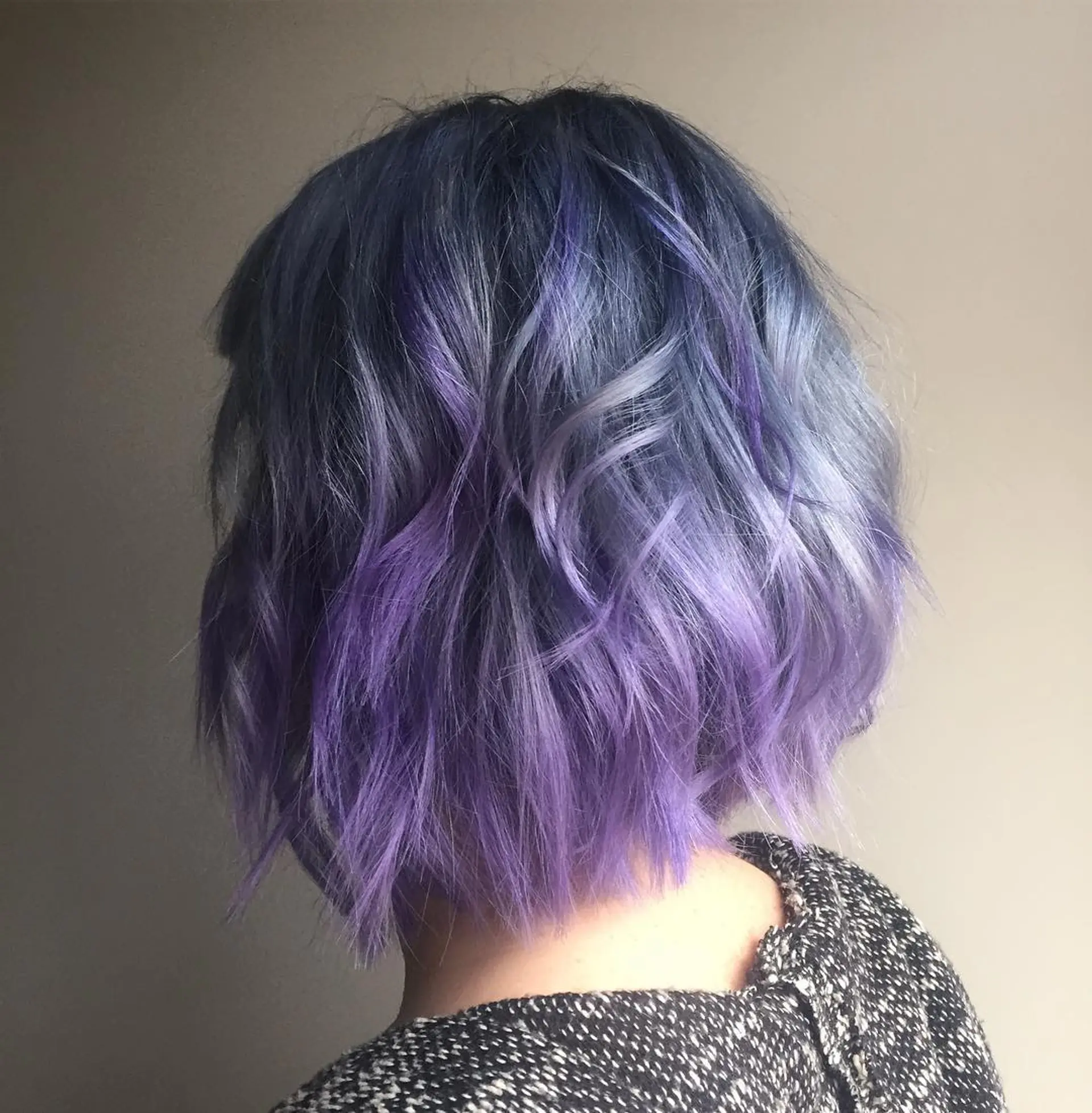 A short, wavy bob with a blue to purple ombre color. 1