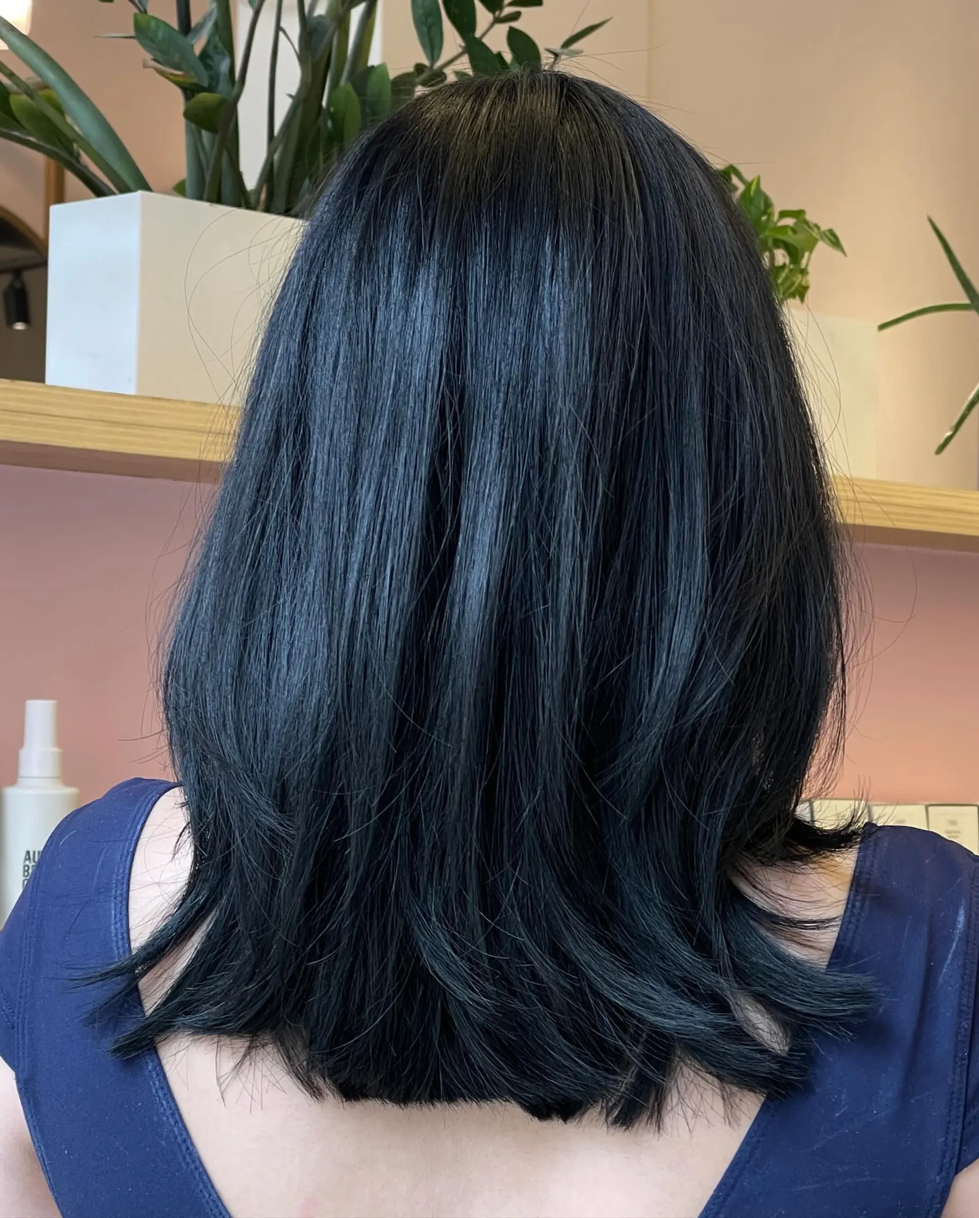 Glossy black medium-length hair cut with soft cascading layers and slightly flipped ends. 1