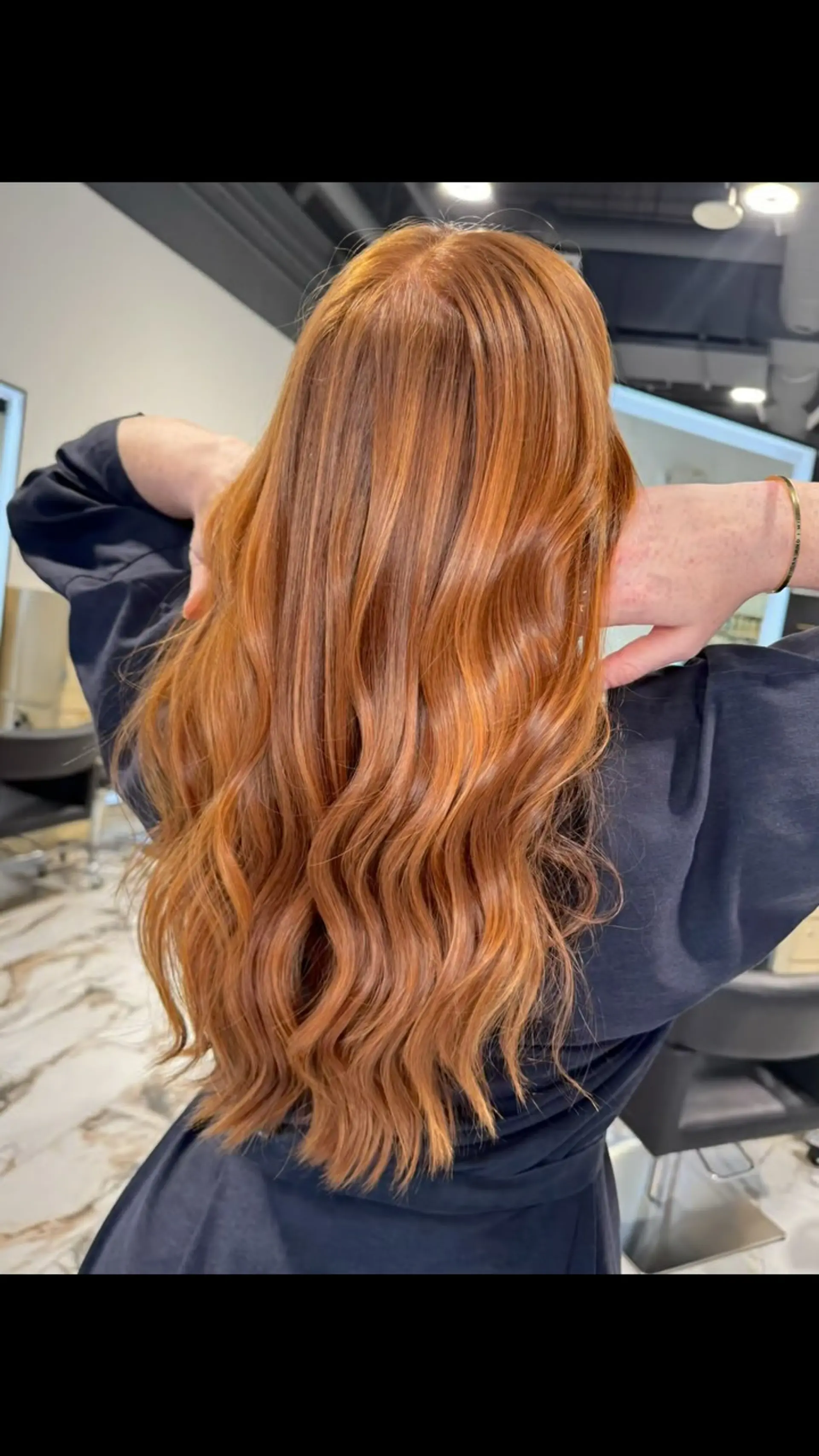 Long, vibrant copper-red hair styled in soft, loose waves cascading down the back. 1