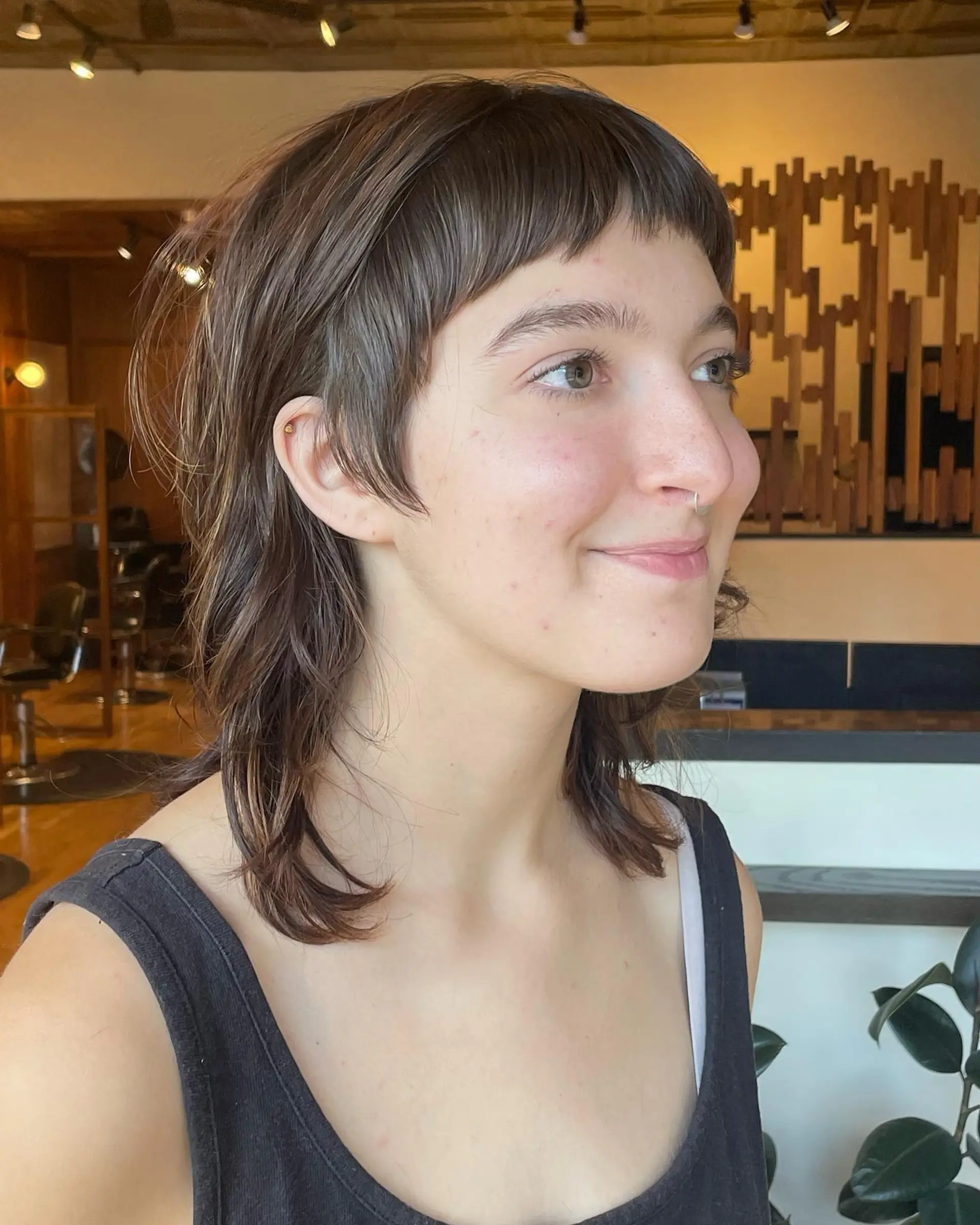 A trendy shaggy mullet featuring short micro bangs and choppy layers. 1