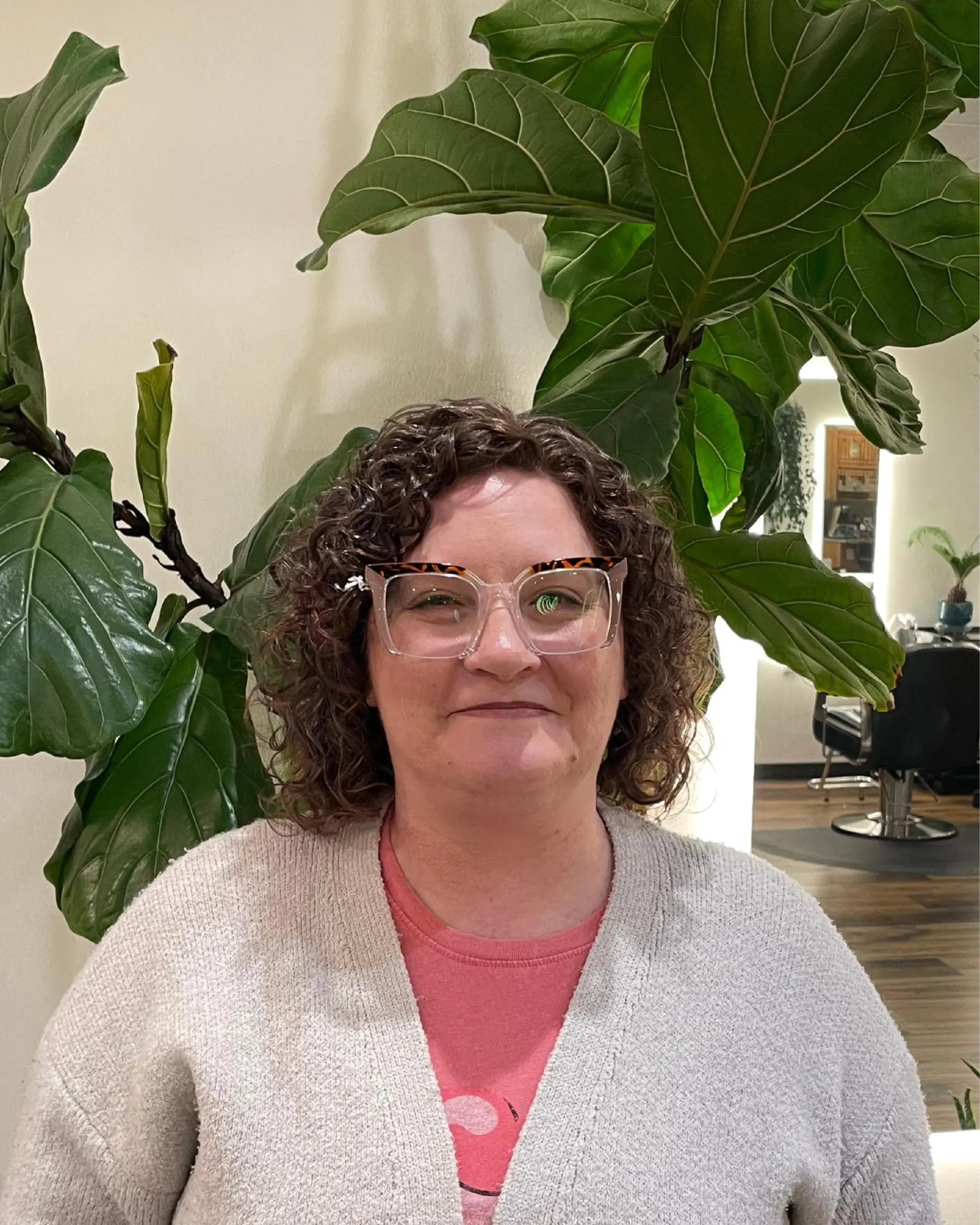 A layered, shoulder-length haircut tailored for naturally curly hair to enhance shape, bounce, and ringlet definition. 1