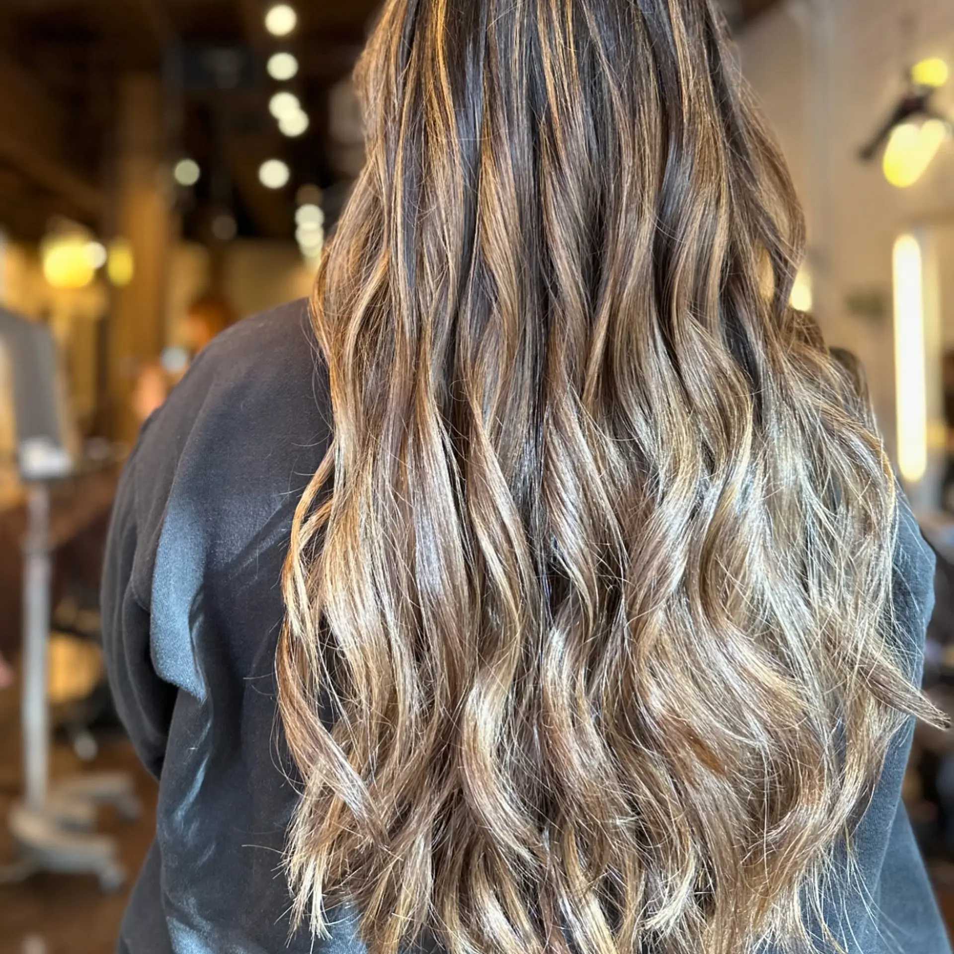 Long, layered hair with soft, loose waves. 2