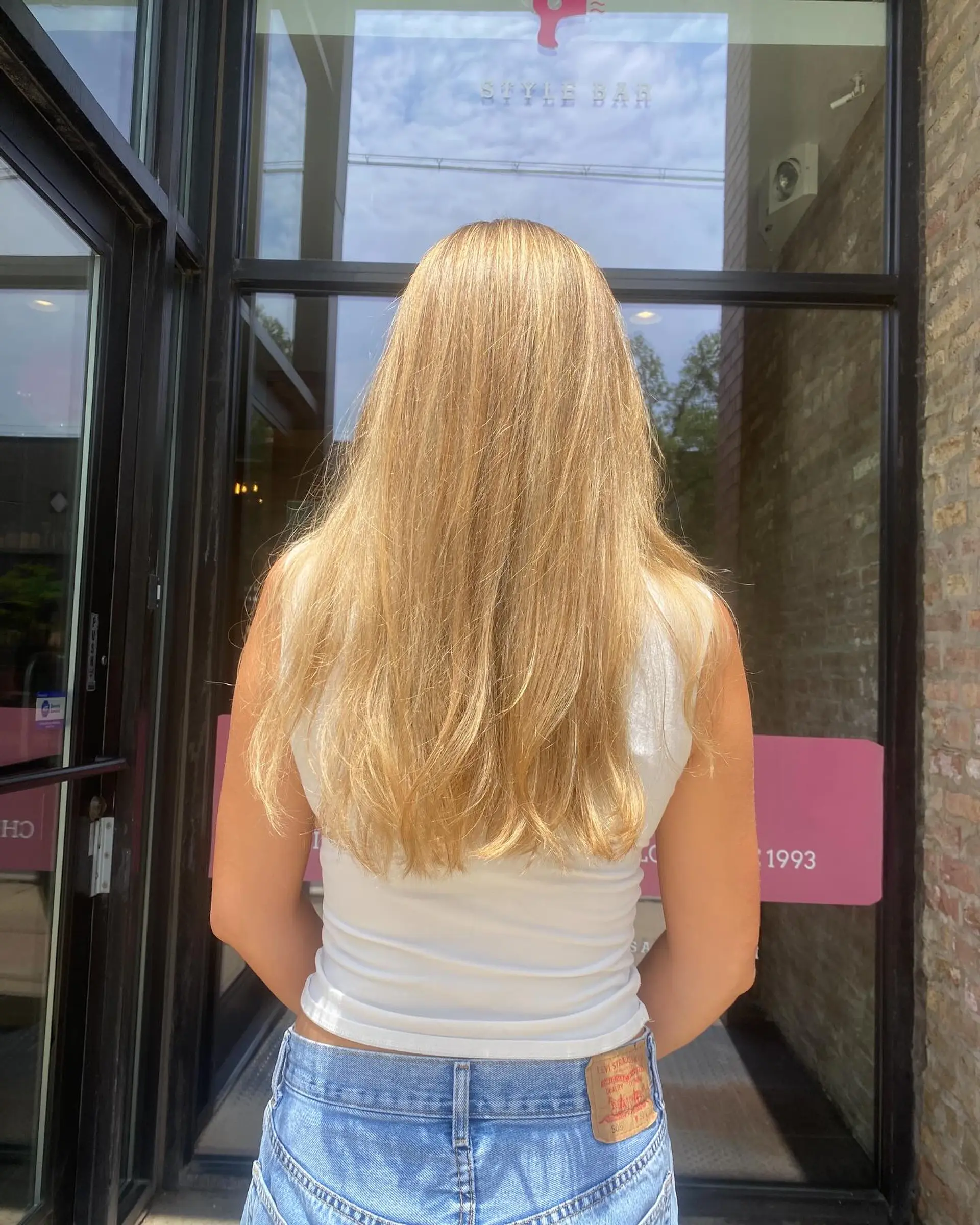 Long, straight blonde hair styled with beachy waves. 2
