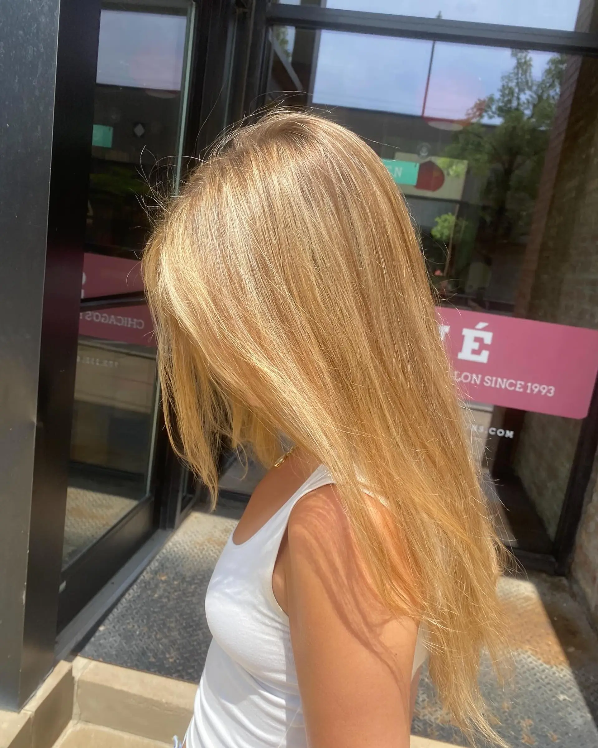 Long, straight blonde hair styled with beachy waves. 3