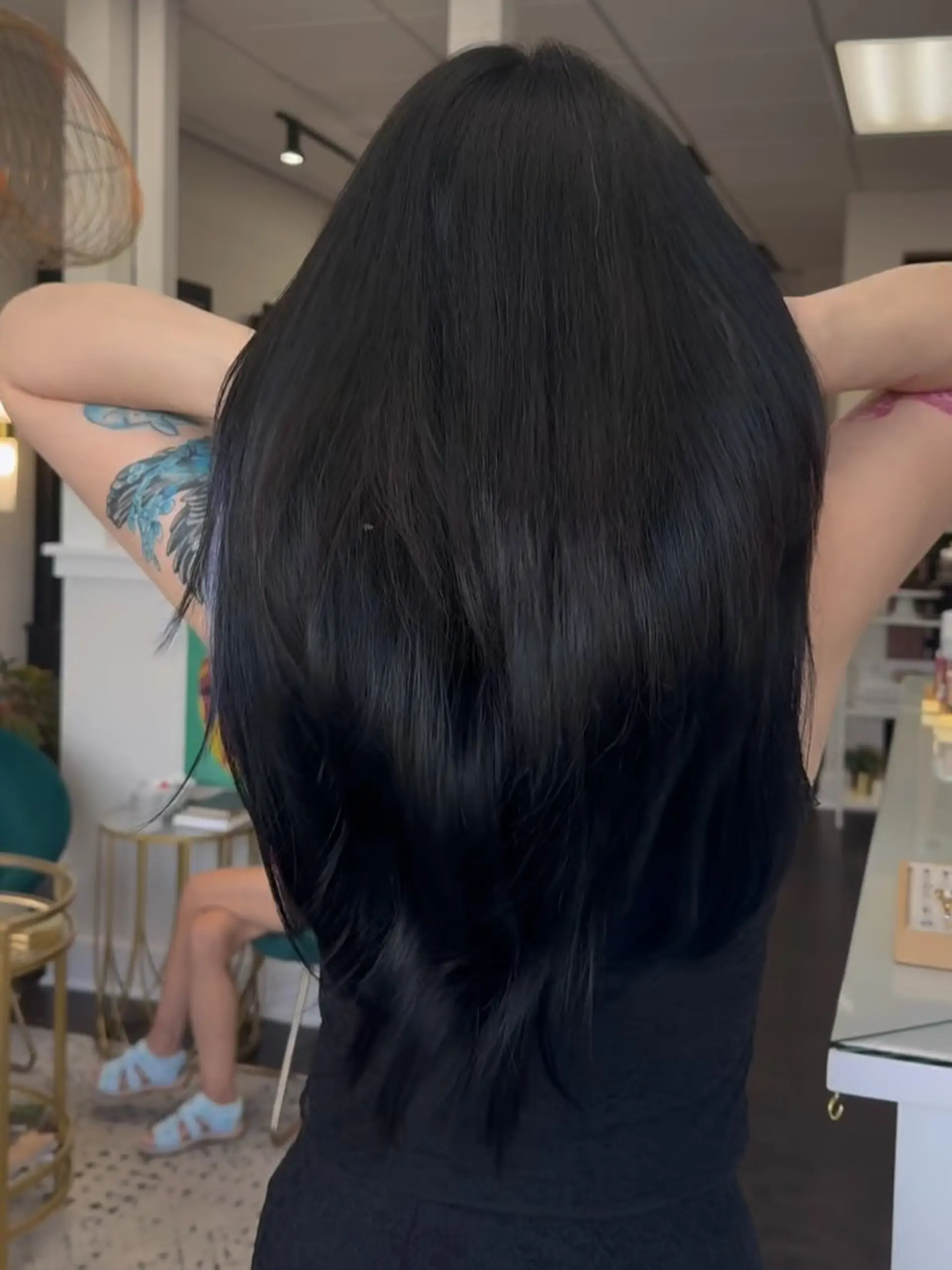 Long, thick jet-black hair with subtle tapering and textured layering at the ends. 1