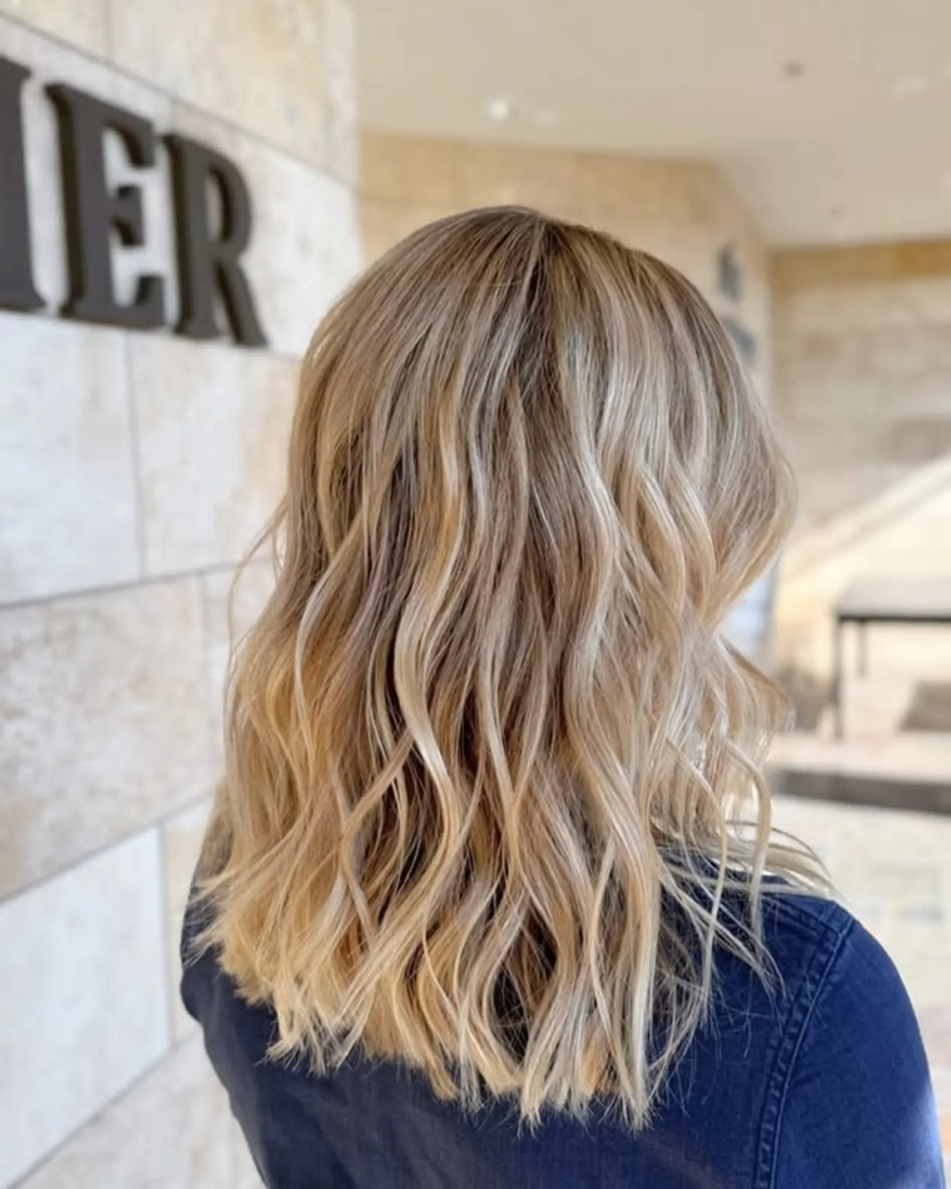 This hairstyle features a bronde color and loose beach waves. 1