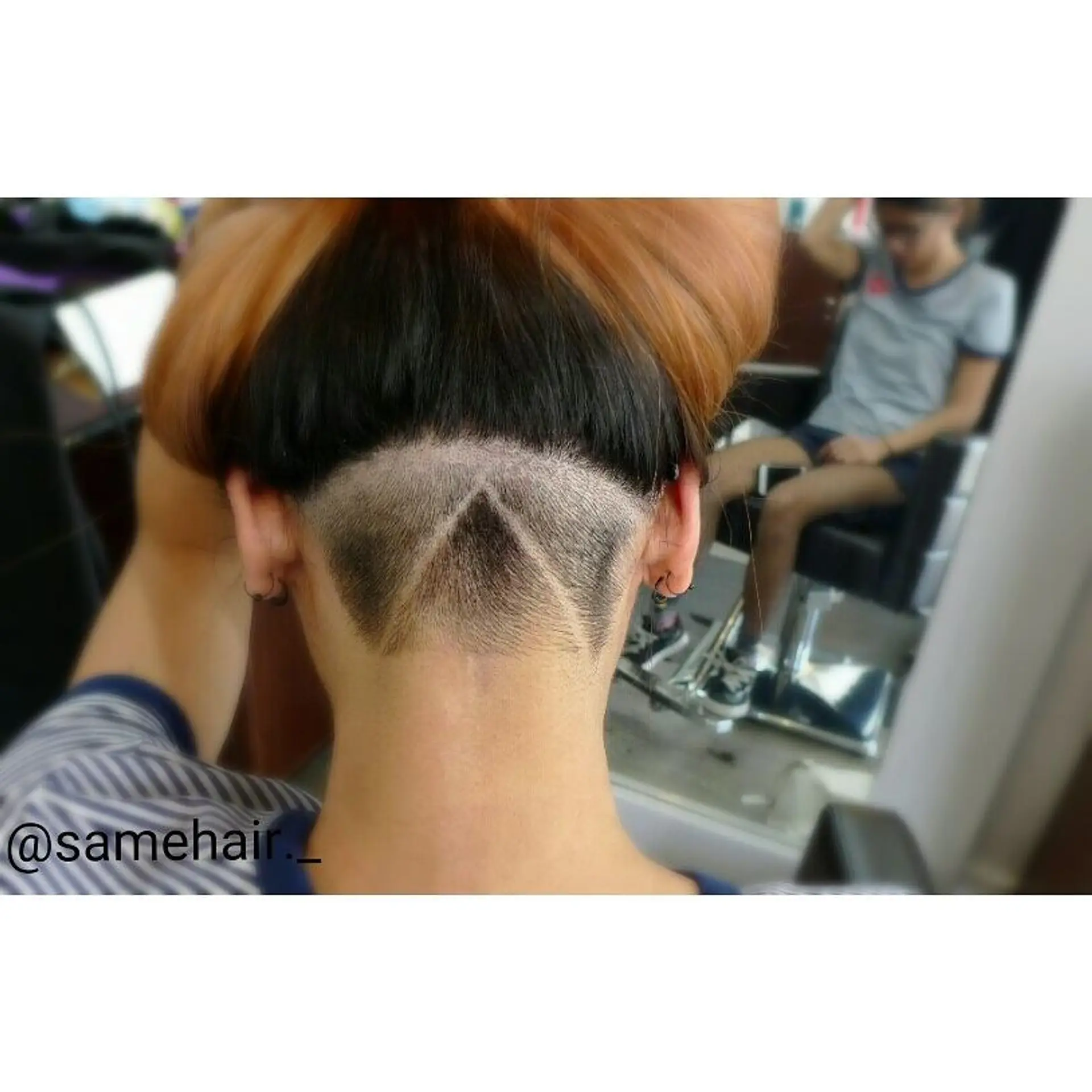 A shaved nape undercut featuring a geometric triangular design carved beneath pinned-up hair. 1
