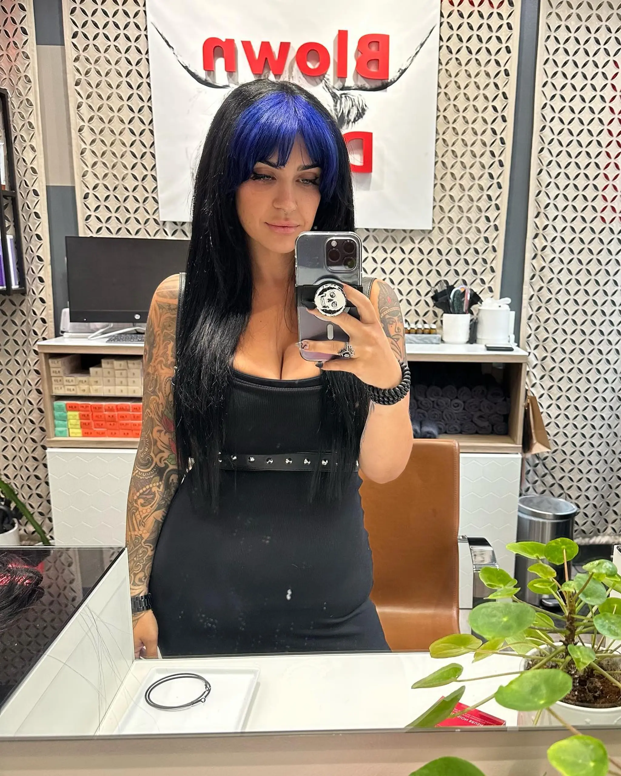 Long straight black hair with blunt electric blue bangs. 1