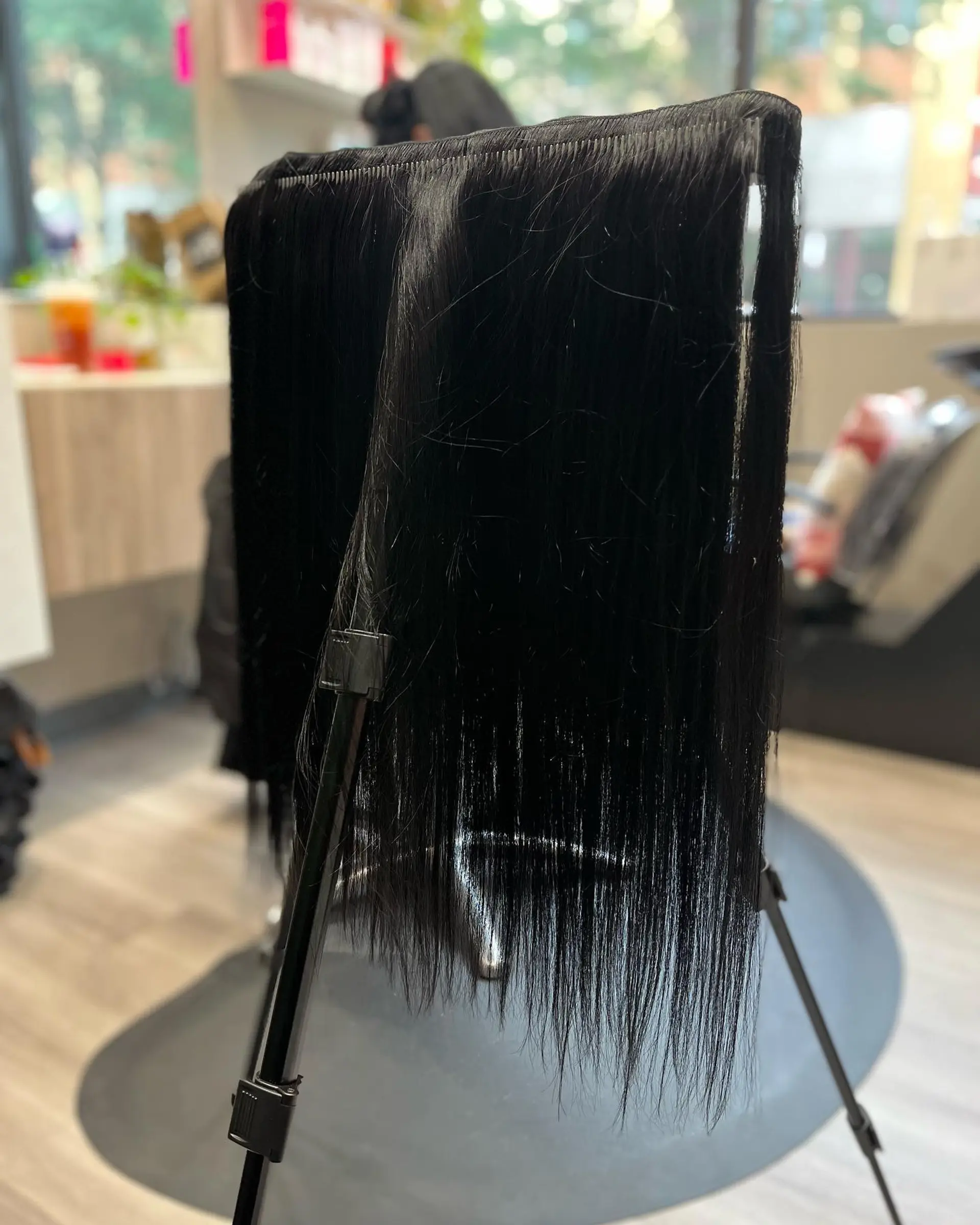 Long straight black hair with blunt electric blue bangs. 2