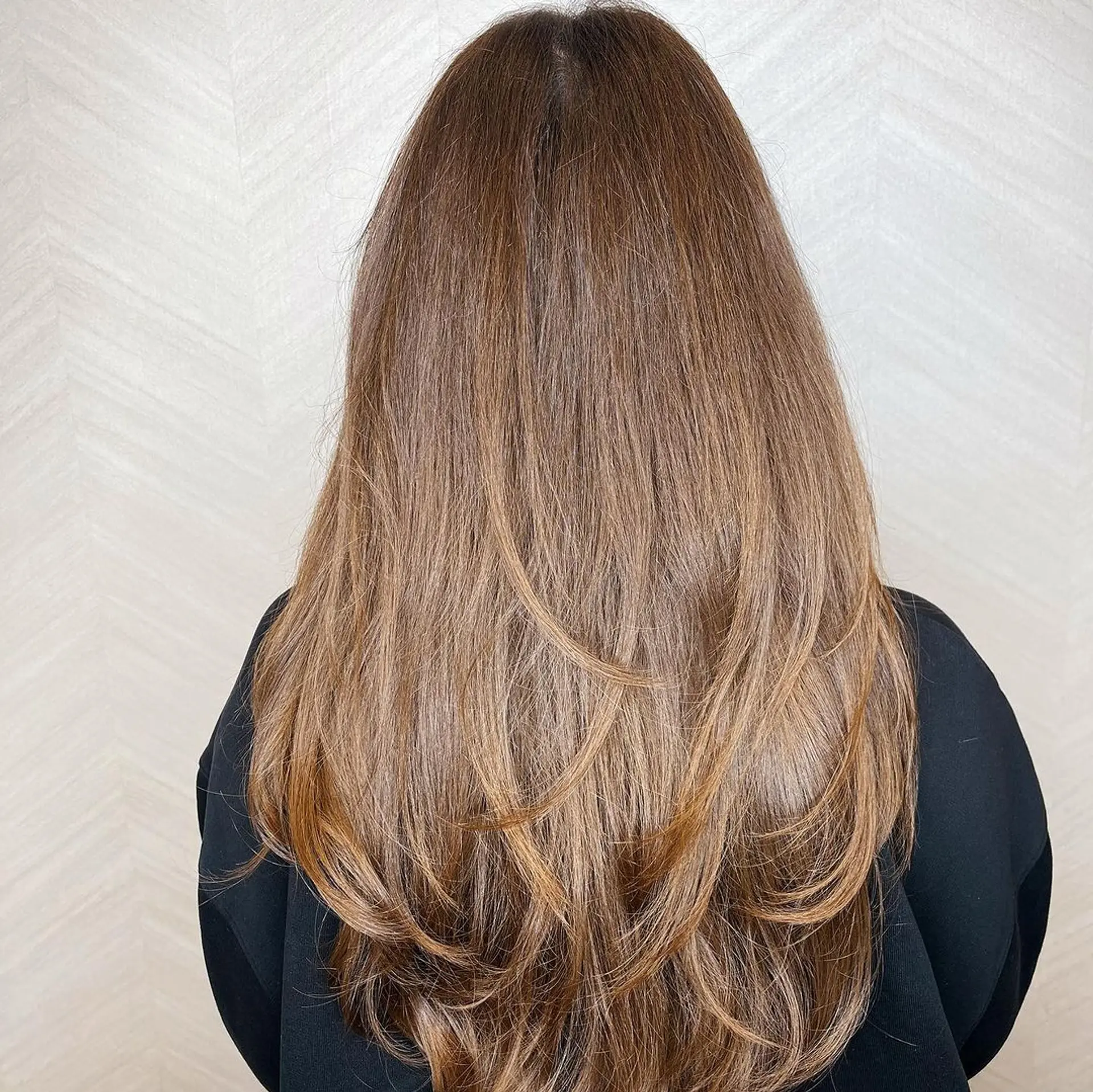 This elegant and very long hair in Chestnut Brown features a blend of natural waves and long, choppy bangs with subtle layering.

Cut and style by @juliamannino_hair 2