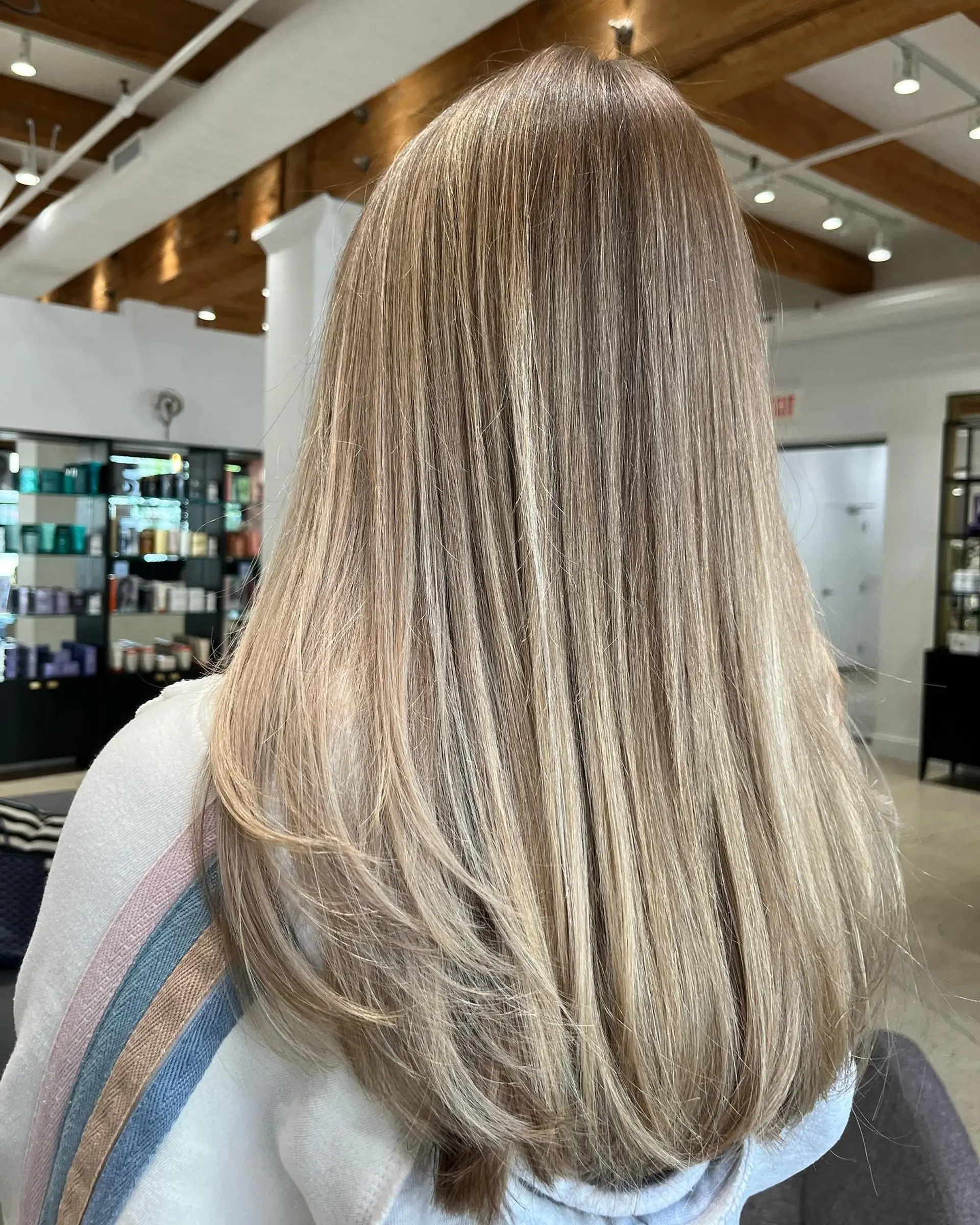 Long, straight hair with dimensional blonde coloring and face-framing layers. 1