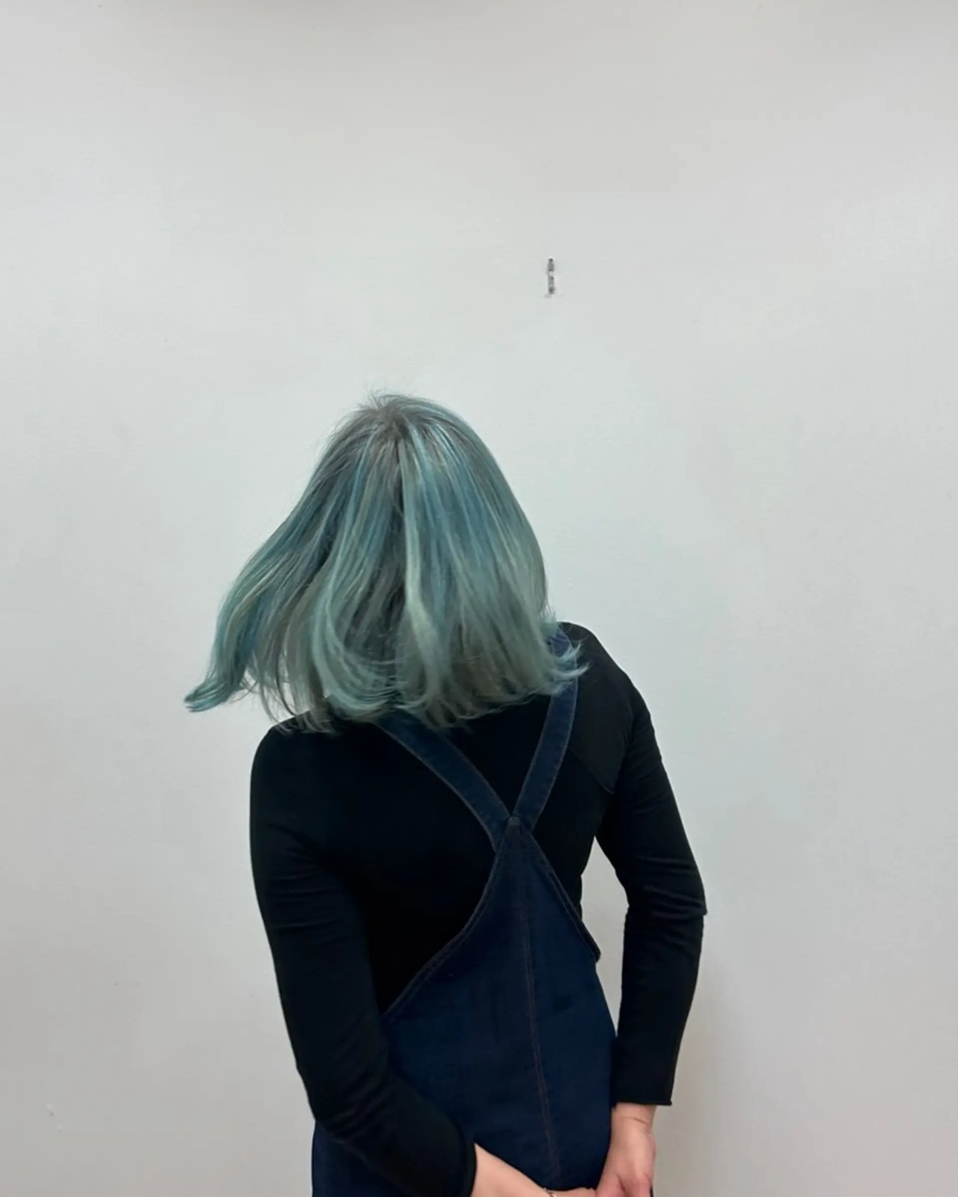 A shoulder-length blunt bob featuring a soft pastel teal and dusty blue fantasy color. 1