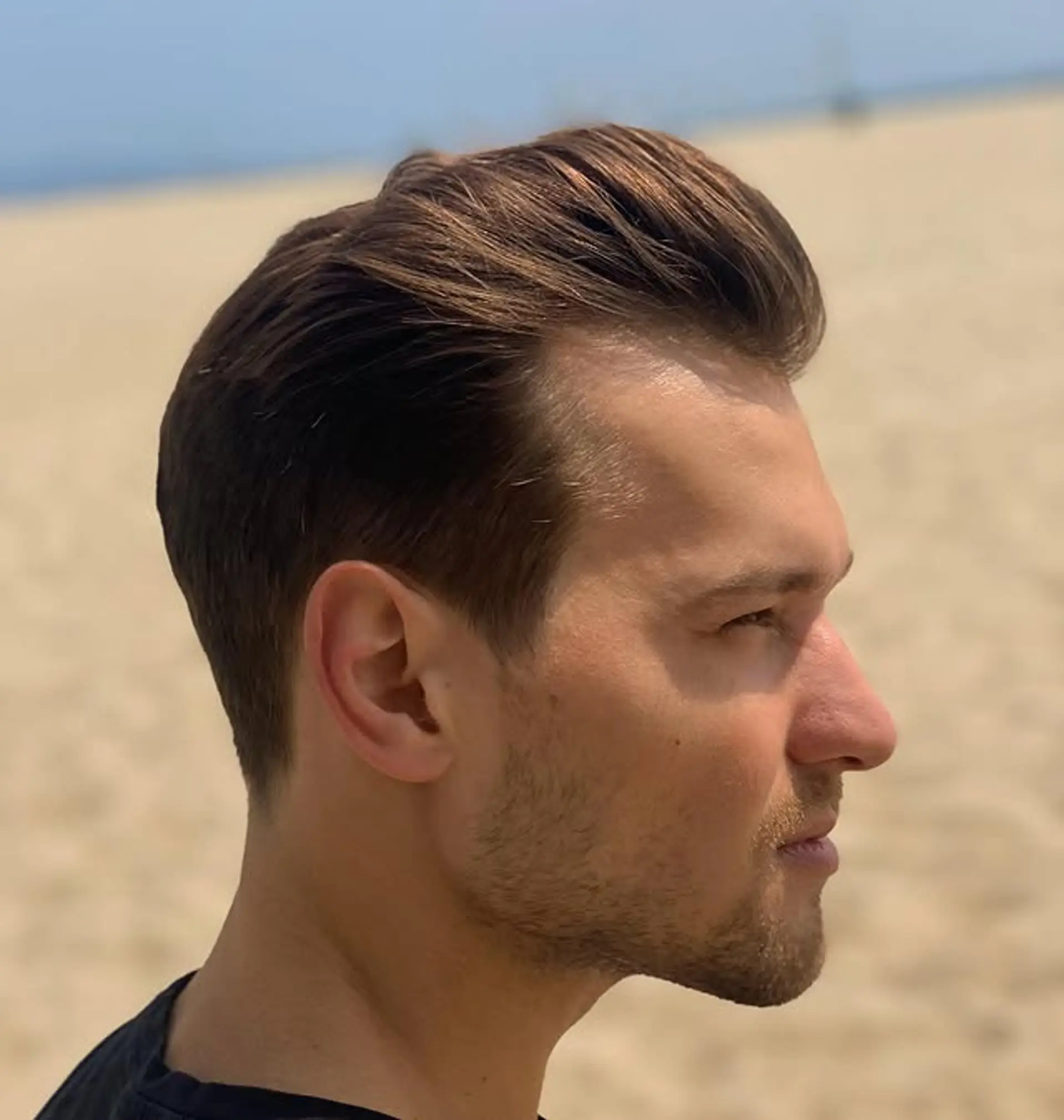 A classic pompadour with a modern fade, slicked back for a clean and stylish look. 1