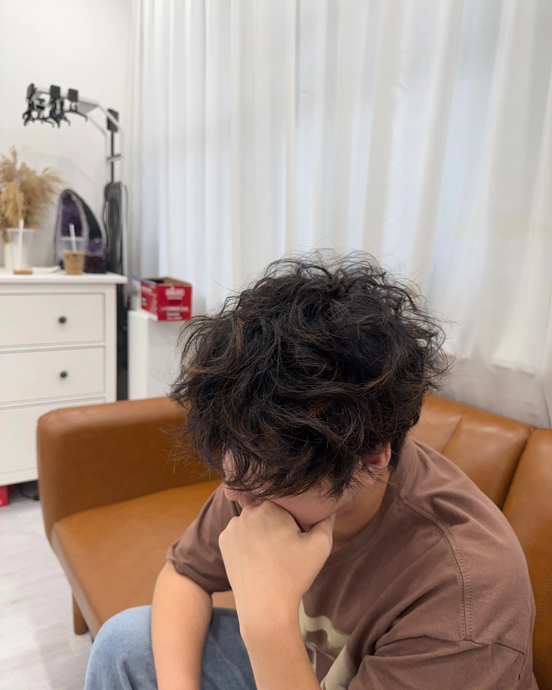 A stylish medium-length curly hairstyle featuring a modern Korean perm for a textured and fashionable look. 1