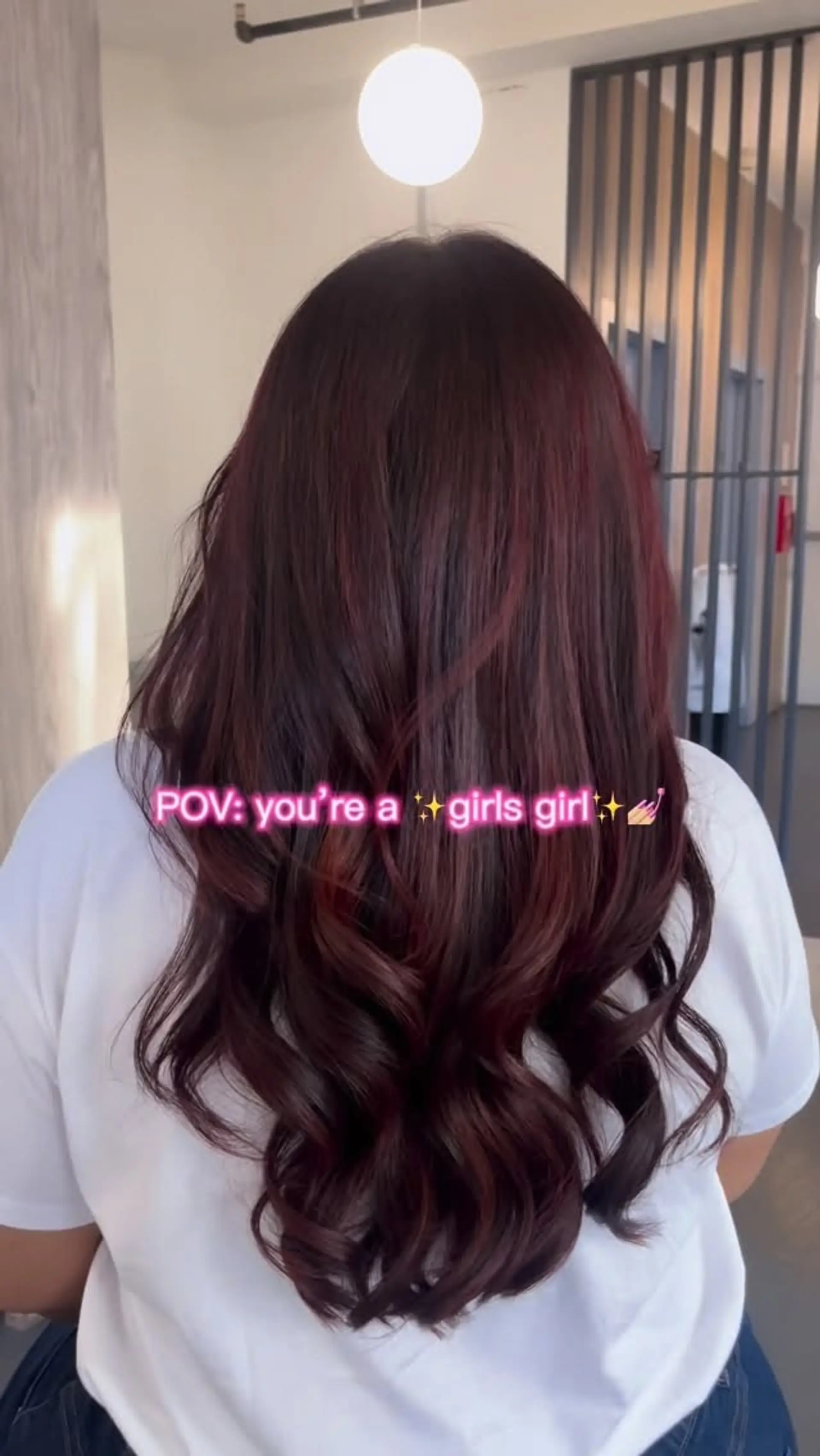 Long deep burgundy hair styled with sleek upper lengths and soft, cascading waves at the ends. 1