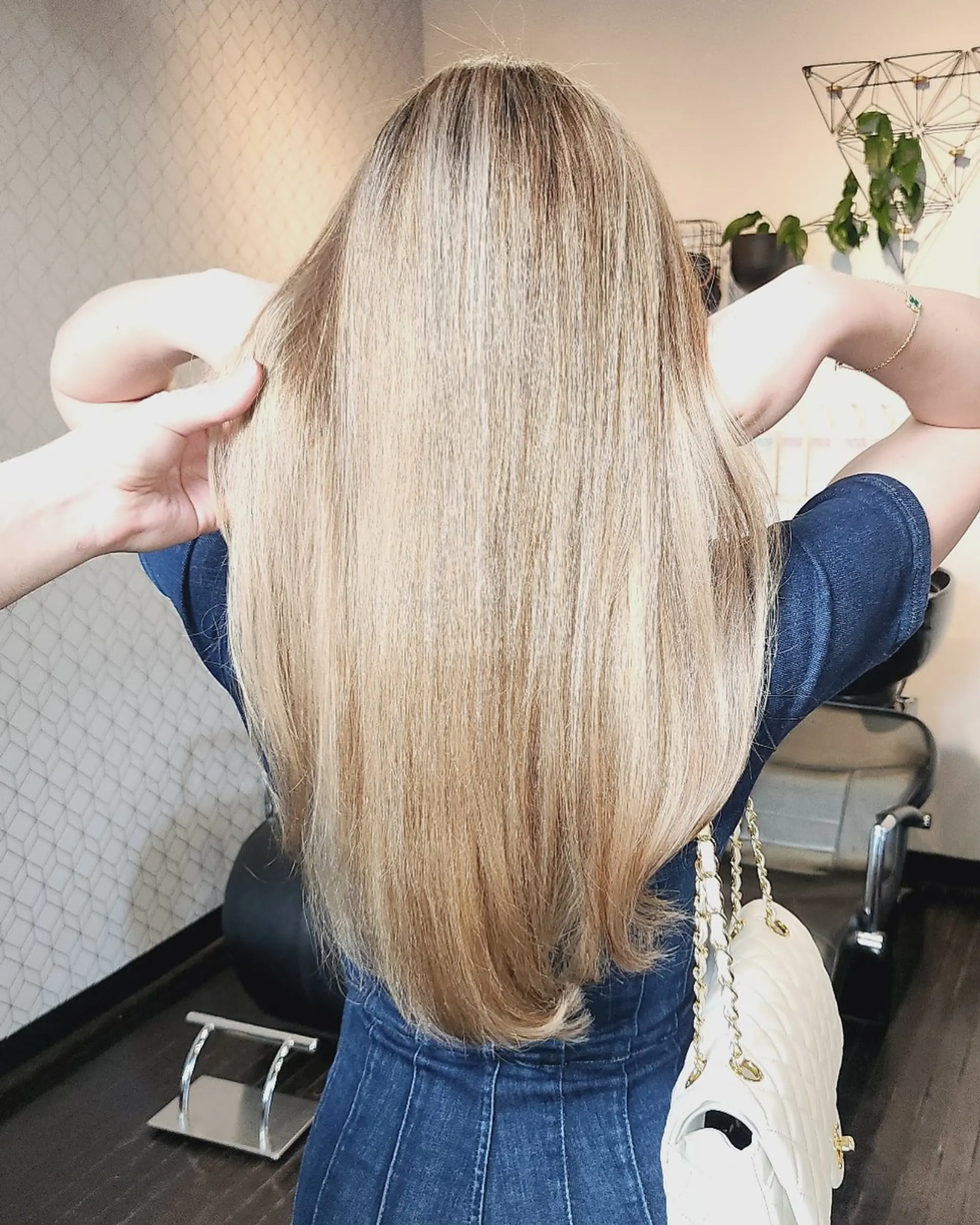 Long, sleek straight blonde hair with blended dimensional highlights and a smooth blowout finish. 1