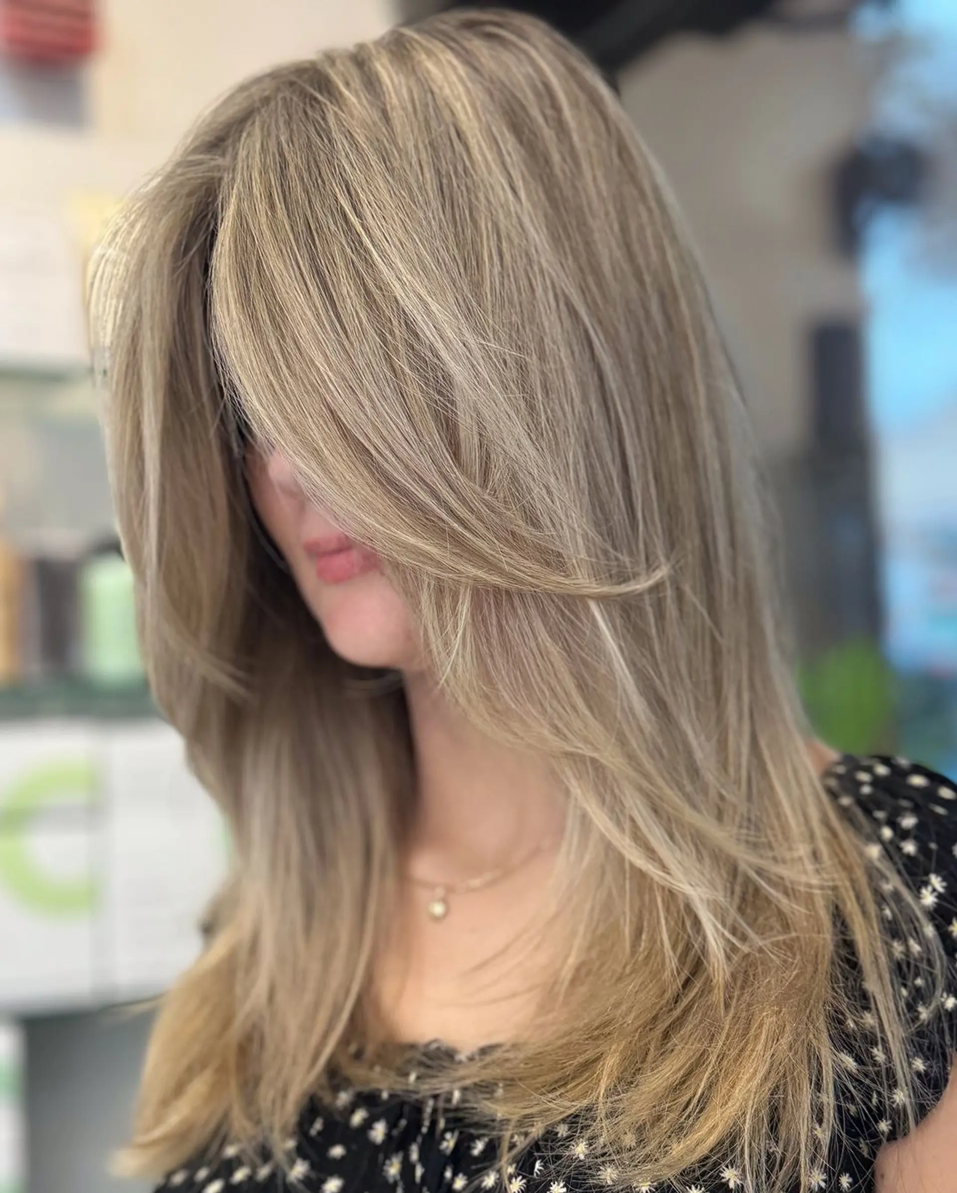 Stunning blonde hairstyle with straight texture, medium length, soft layers, and side-swept bangs featuring multi-toned blonde shades. 2
