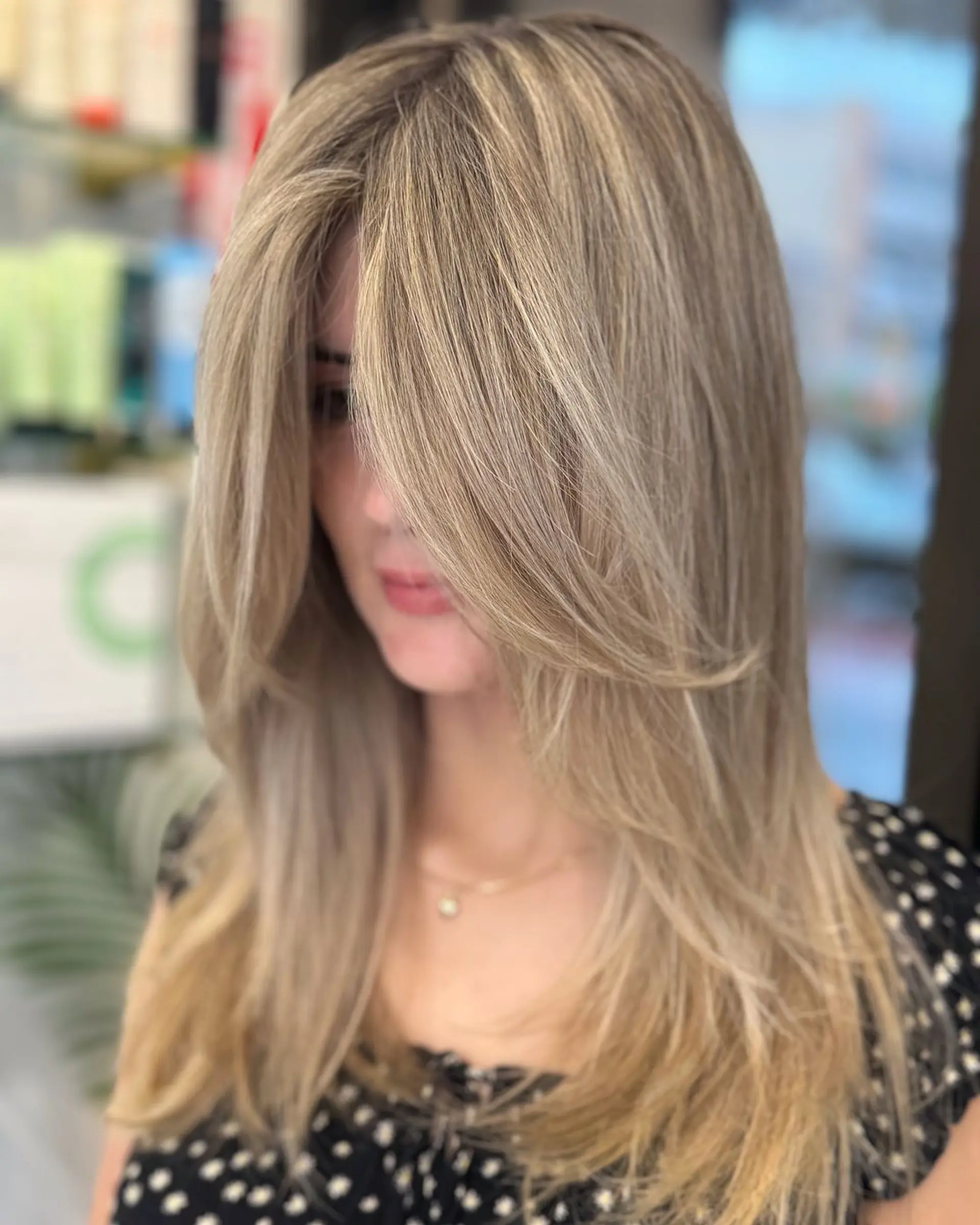 Stunning blonde hairstyle with straight texture, medium length, soft layers, and side-swept bangs featuring multi-toned blonde shades. 3