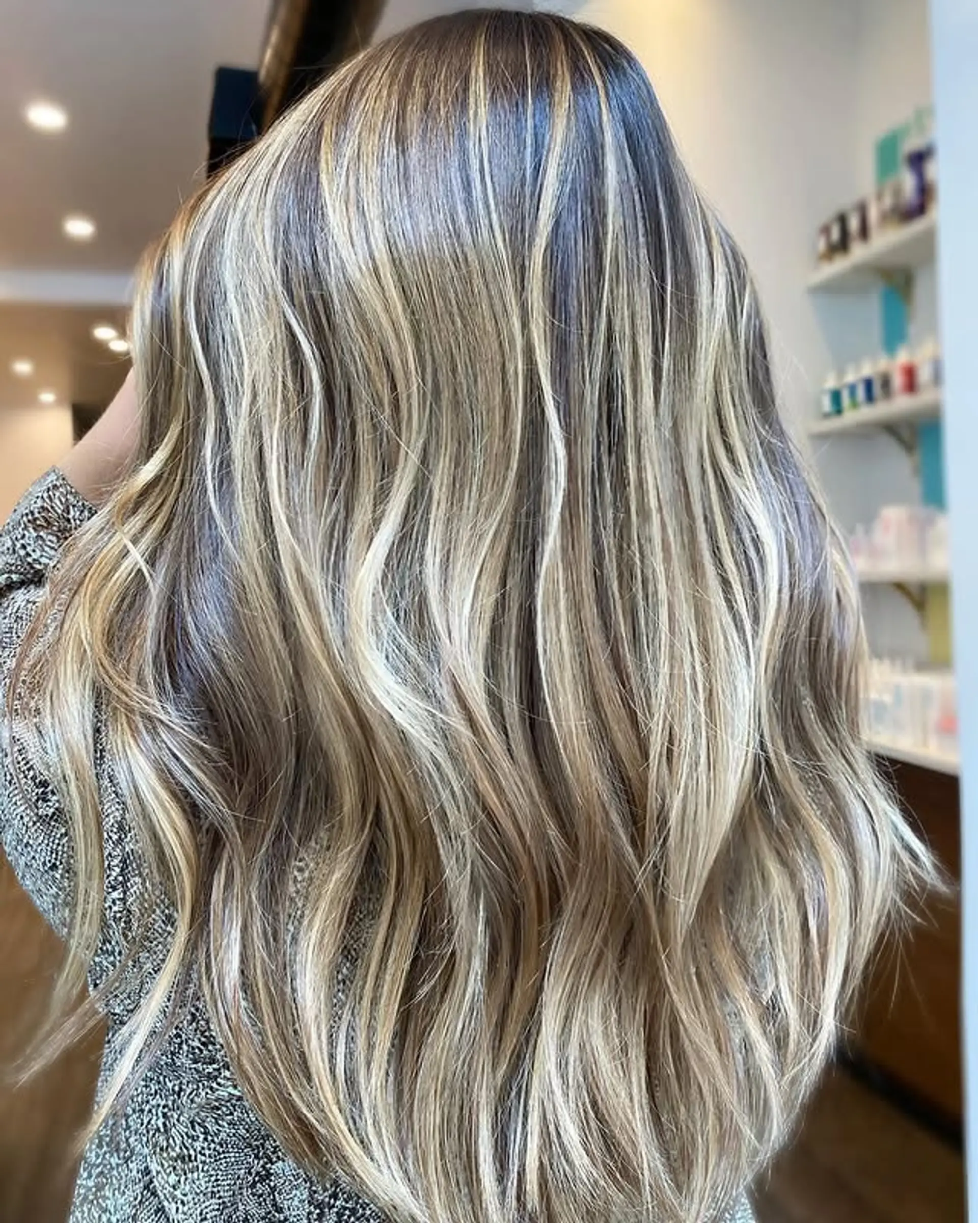 Long, wavy hair with a bronde balayage that blends blonde and brown tones seamlessly. 1