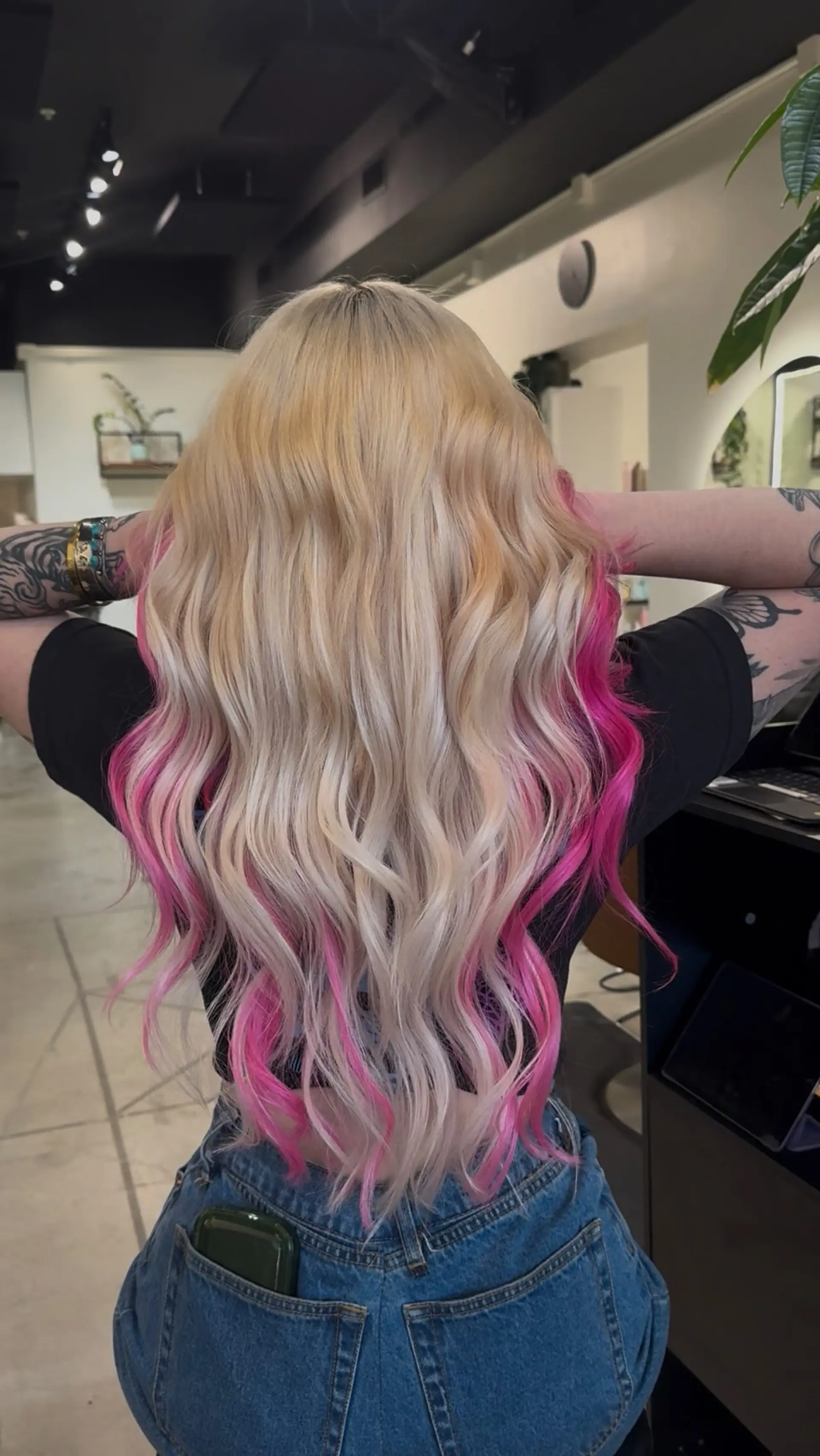 Long platinum blonde hair styled in soft waves with vibrant hot pink peekaboo underlights. 1