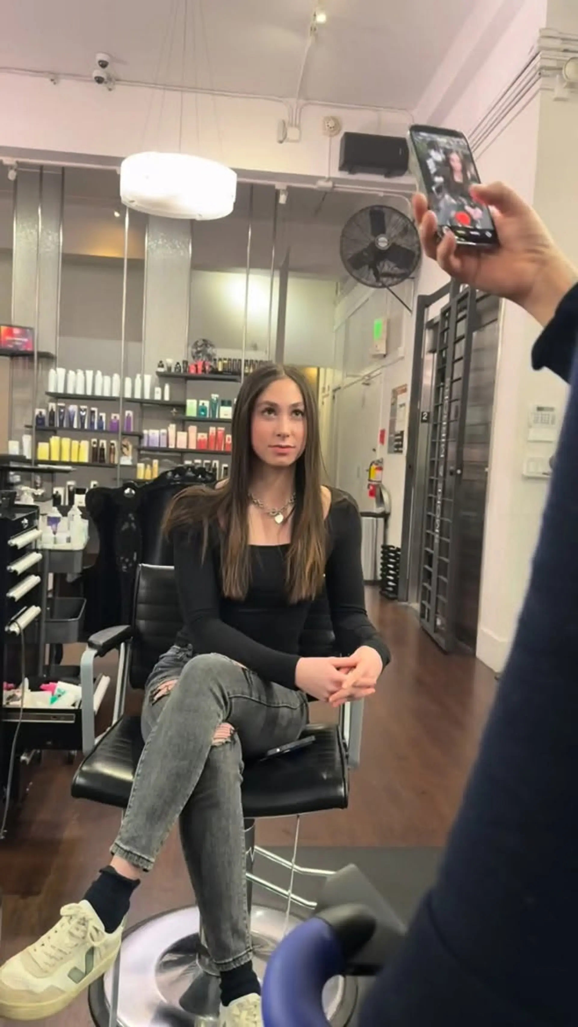 Long, sleek brunette hair parted in the middle and styled pin-straight. 1