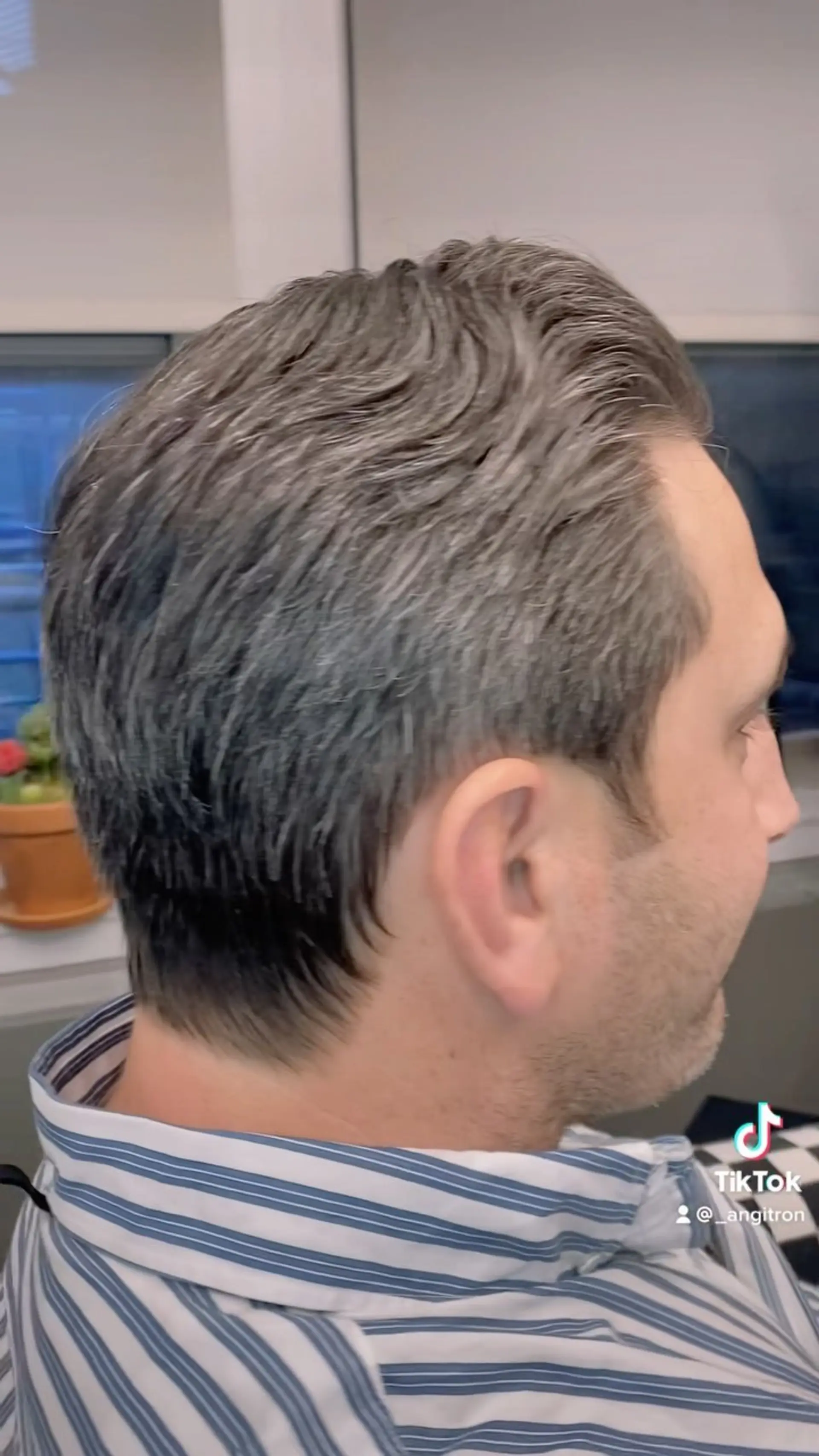 A classic short men's haircut with soft texture and a neatly tapered neckline. 1