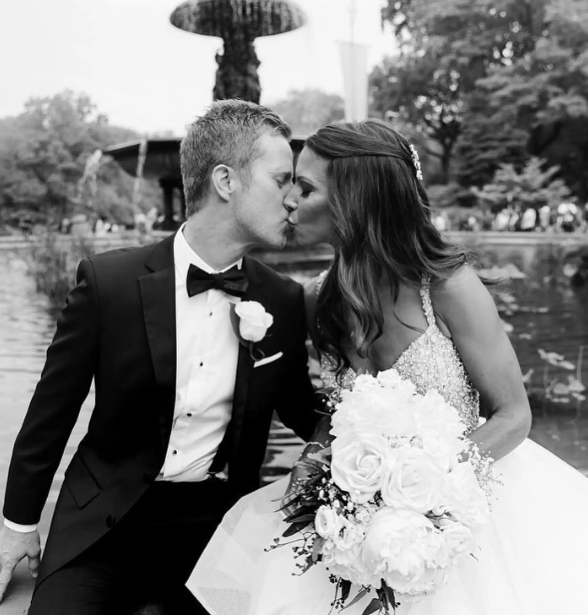 Long brunette hair styled into gentle, voluminous waves with a half-up style. Features soft waves and a delicate hair accessory, creating a romantic bridal look. 2