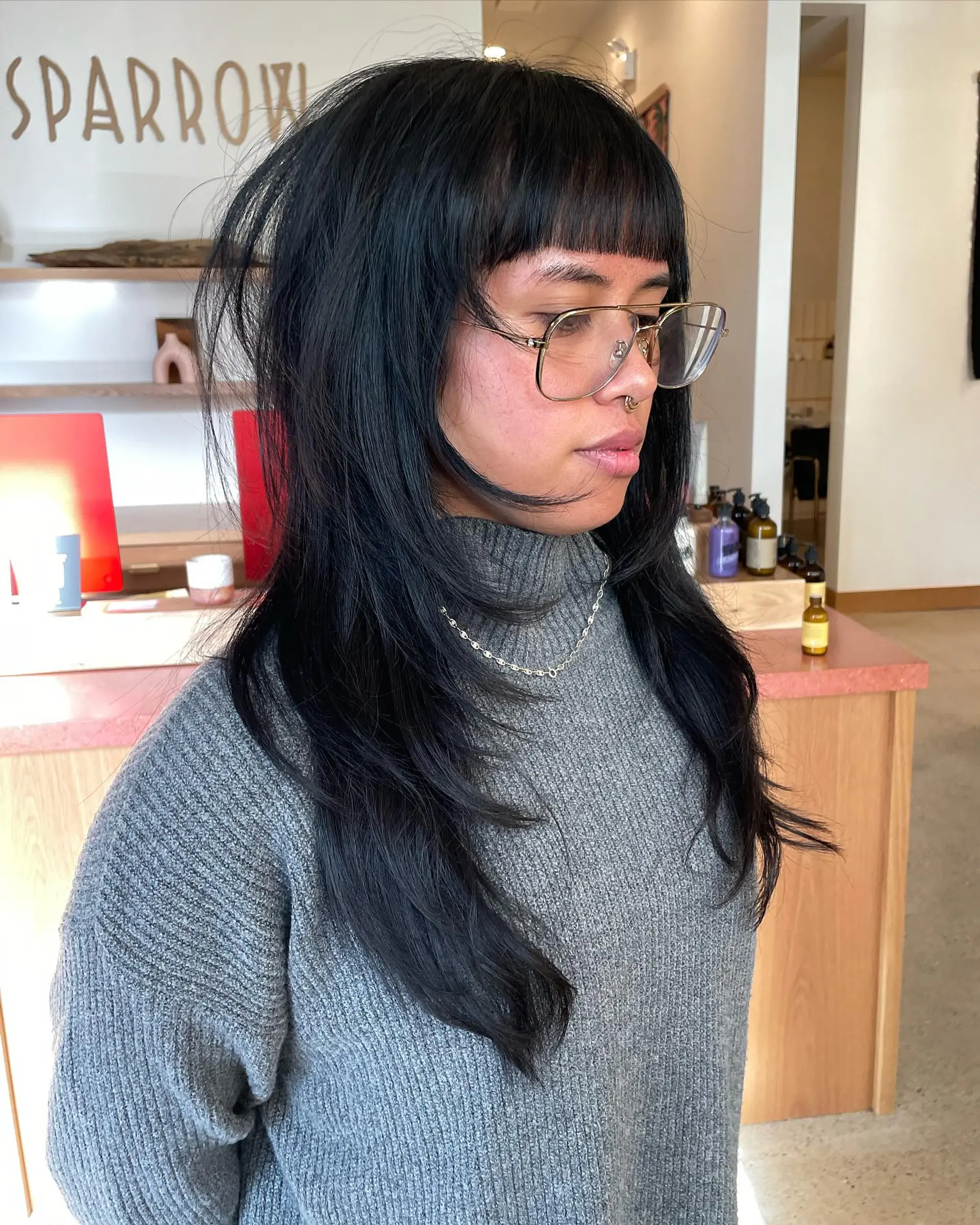 A modern shag haircut with choppy layers and blunt bangs. 1