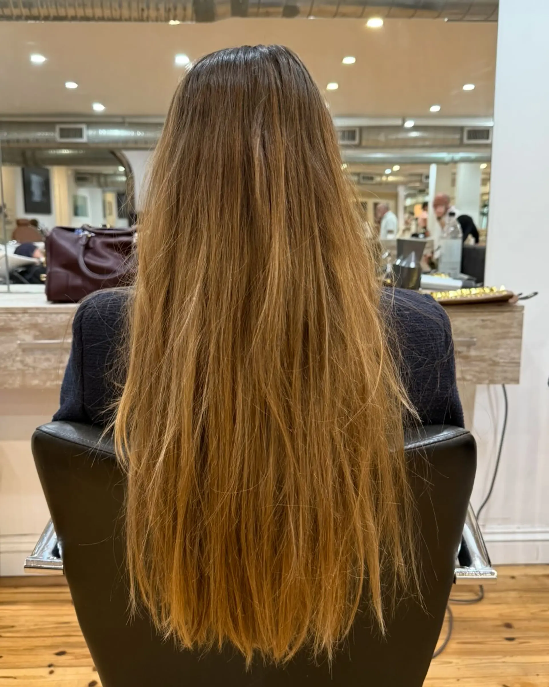 Long, wavy hair with soft layers and a honey blonde balayage. 2