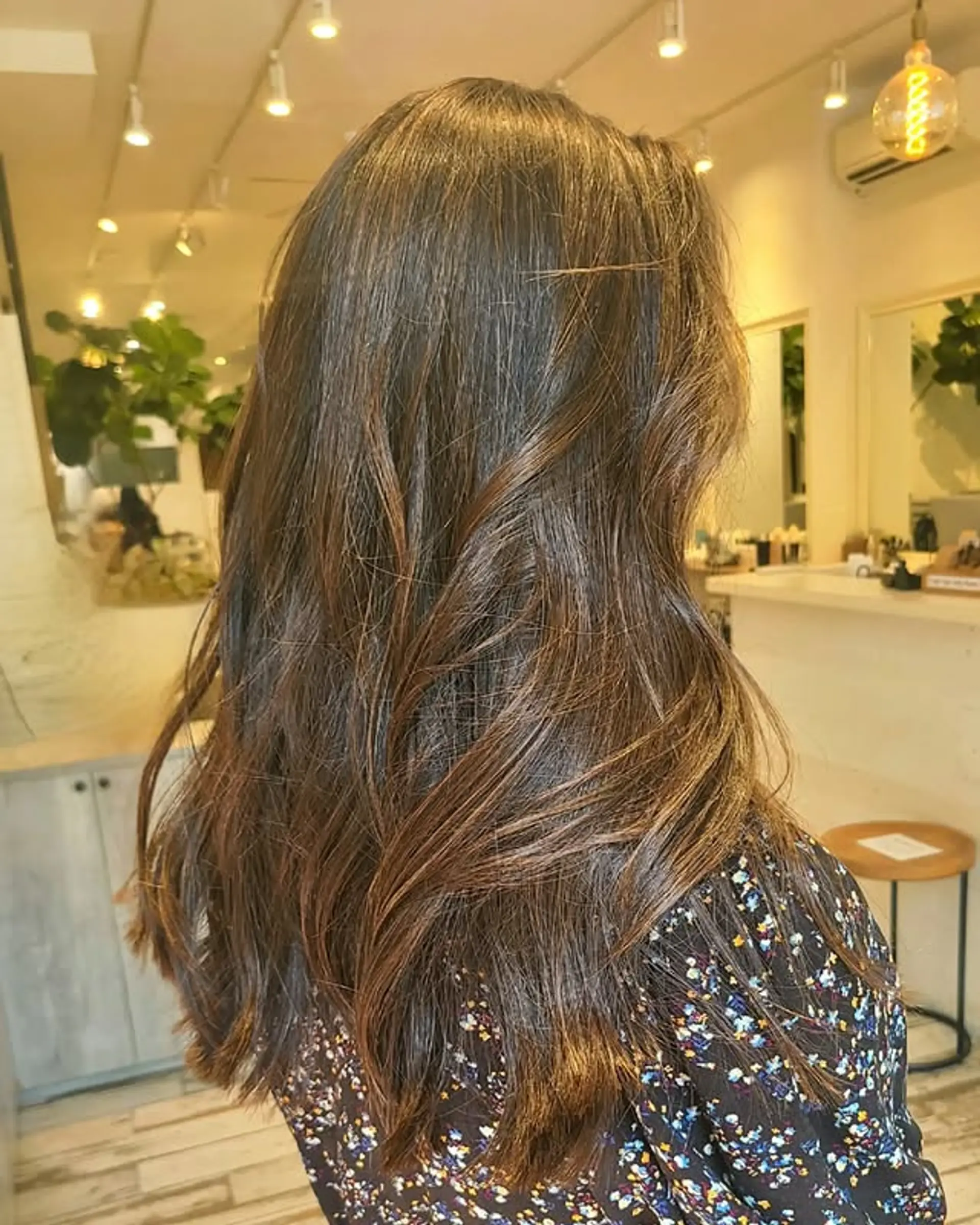 Long layered haircut with soft waves and bronze highlights. 1