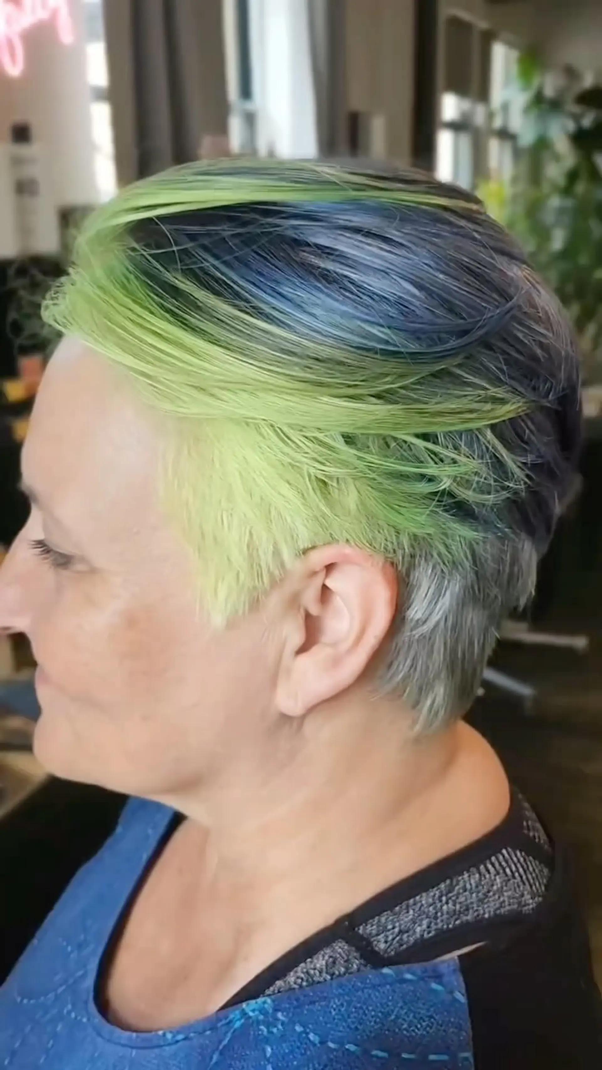 A textured short pixie cut featuring vibrant lime green and dusty navy blue fashion colors brushed back. 1