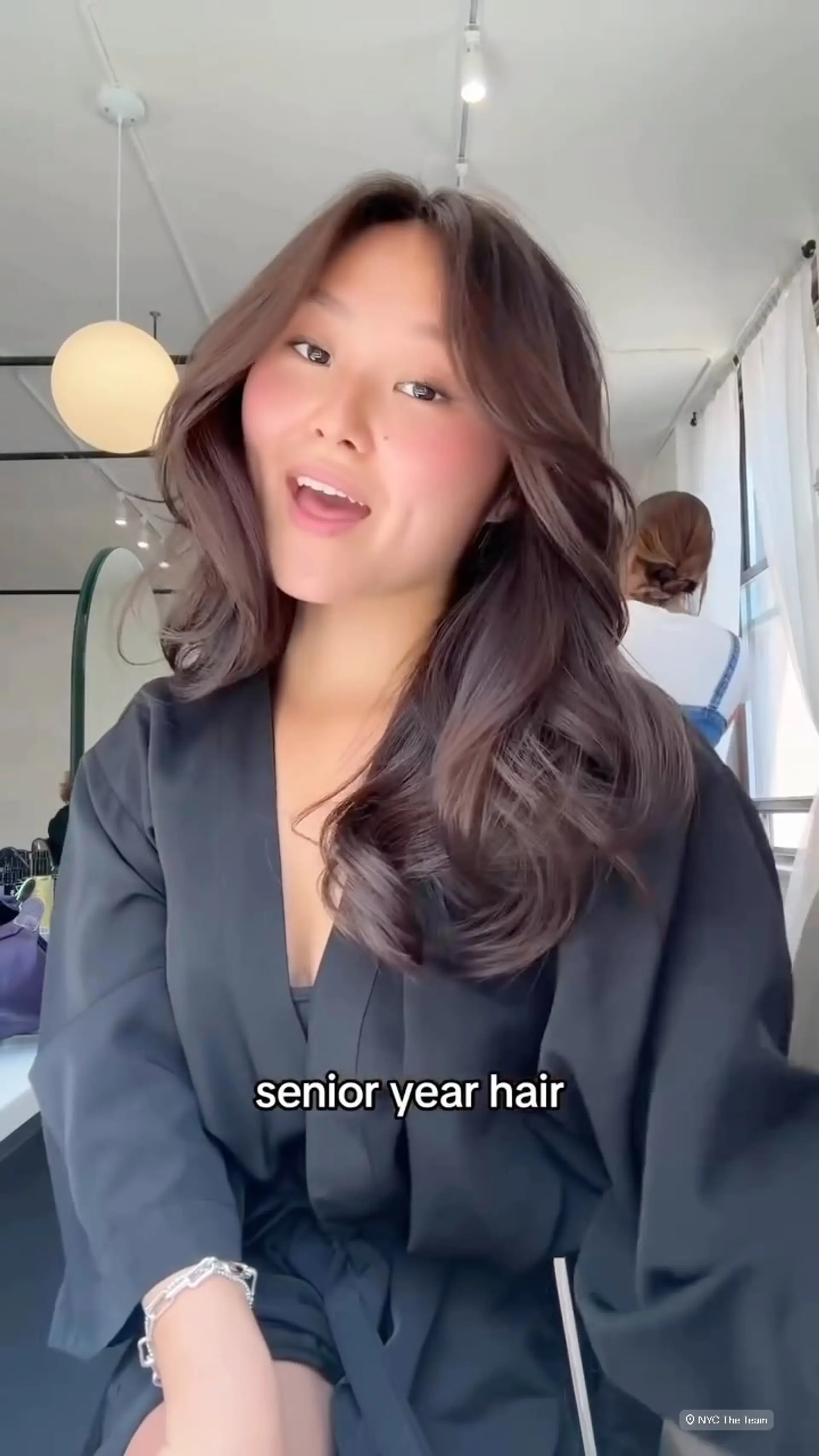 Long chocolate brown hair styled with voluminous body, soft waves, and face-framing curtain bangs. 1