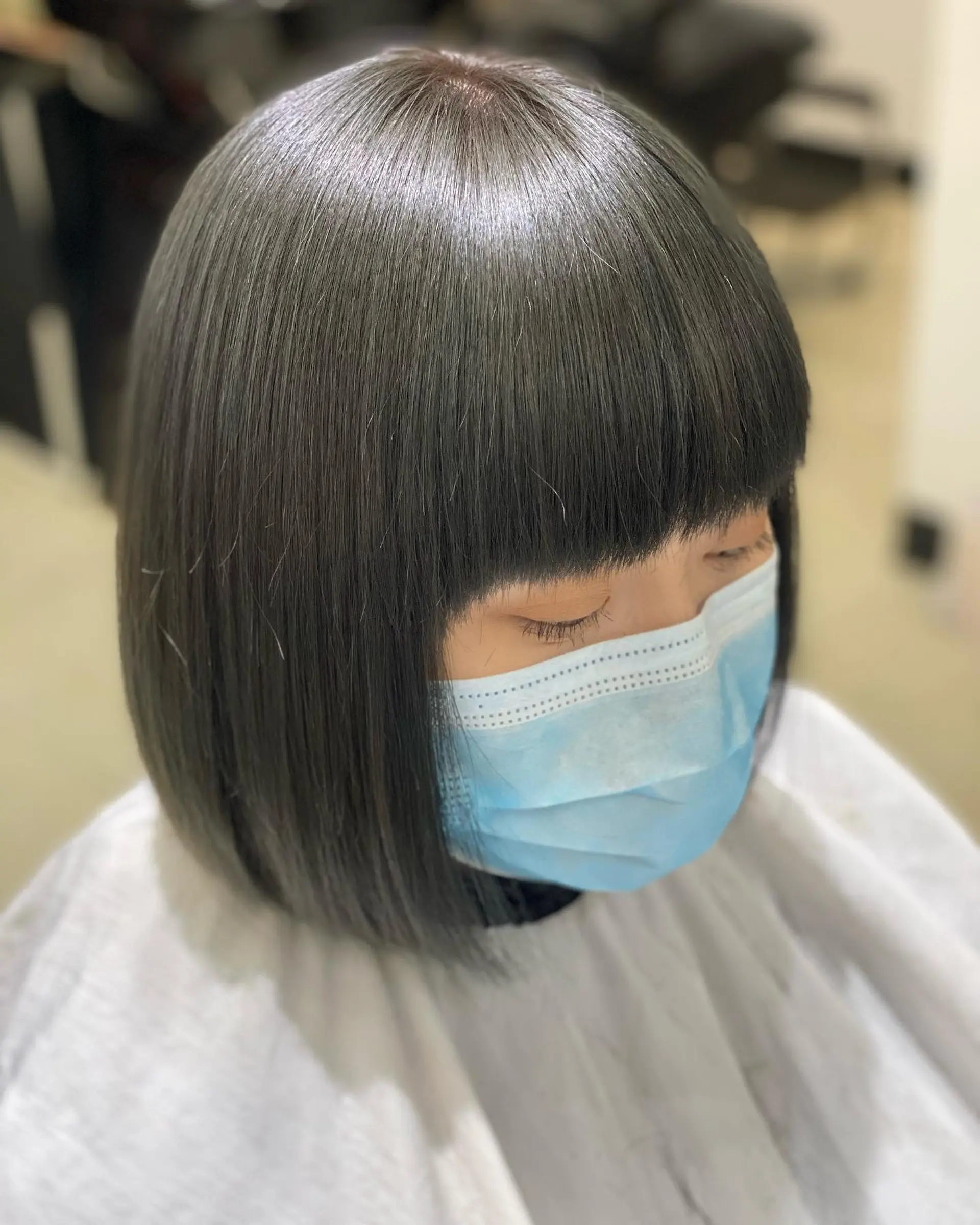 A medium length, sleek, straight blunt bob with a full, blunt fringe. 1