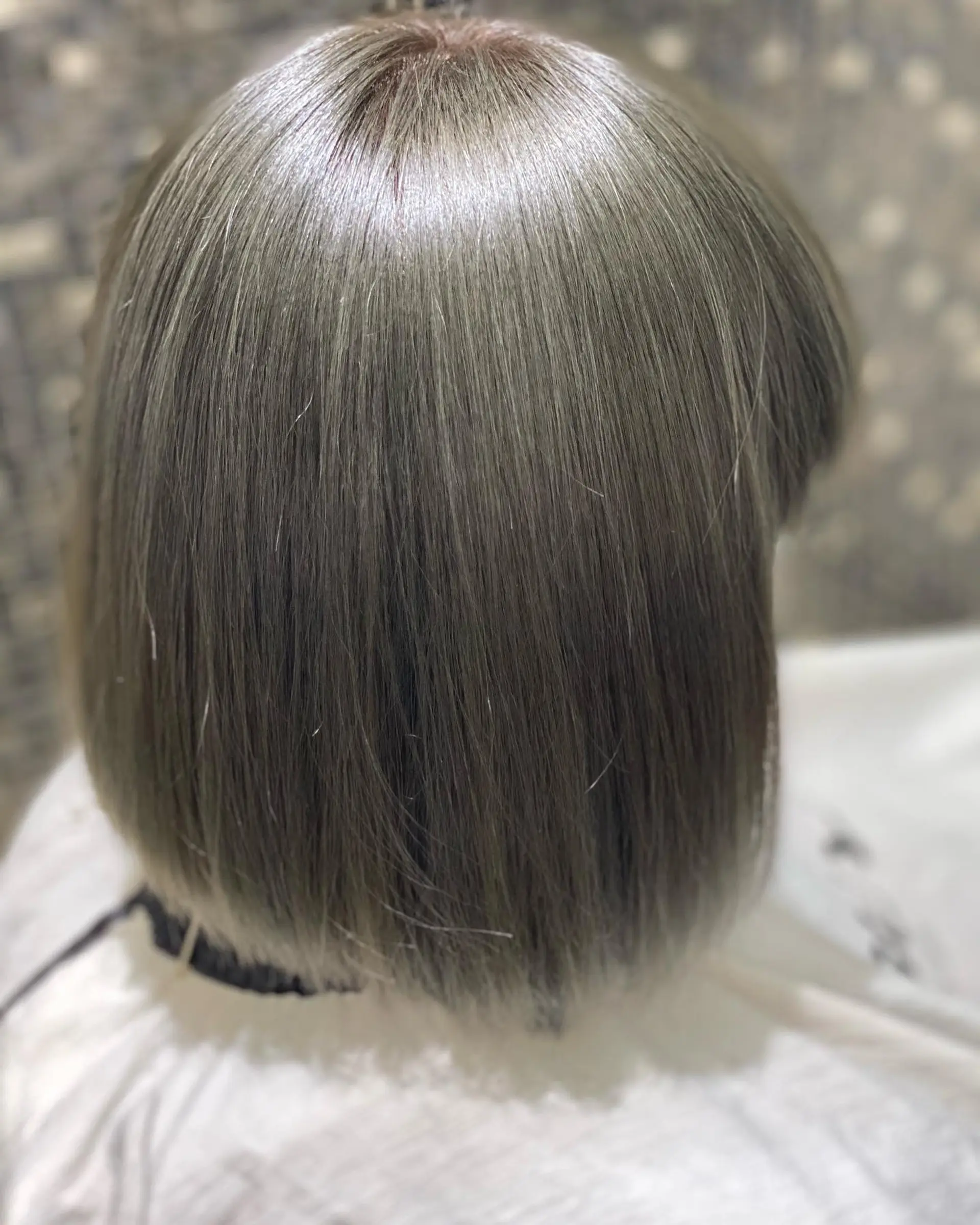 A medium length, sleek, straight blunt bob with a full, blunt fringe. 2