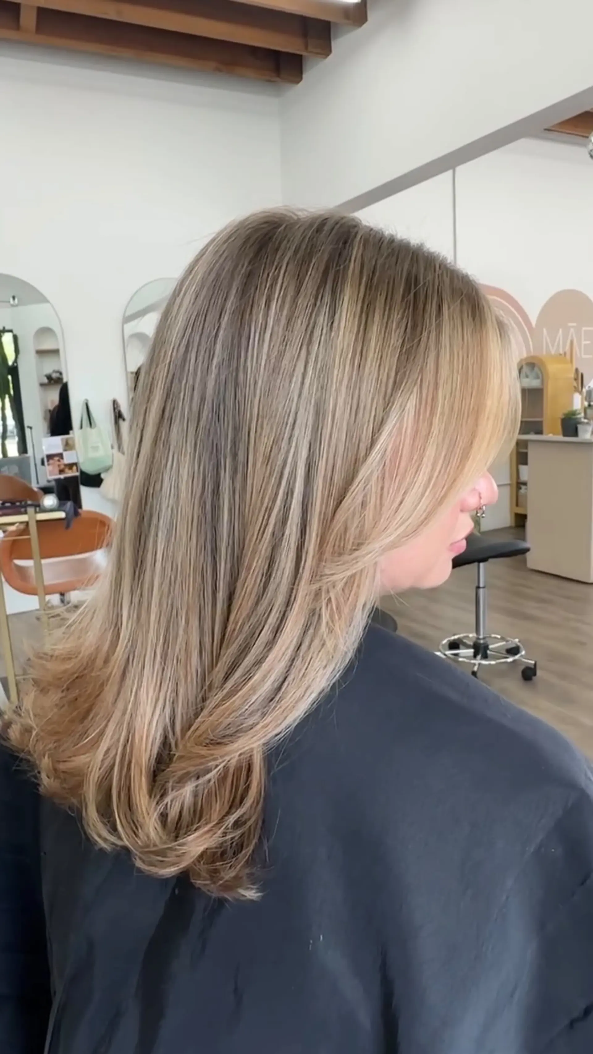 Long dimensional blonde hair styled in a smooth blowout with soft, face-framing layers. 1