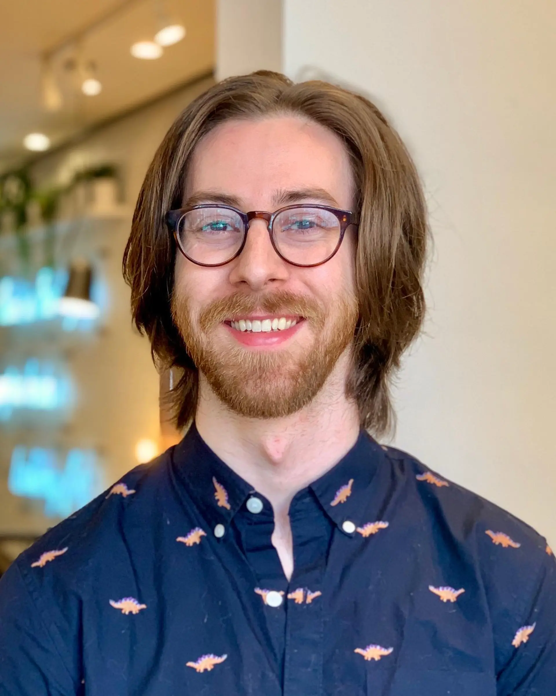 A classic medium-length flow haircut with a center part and natural waves. 1