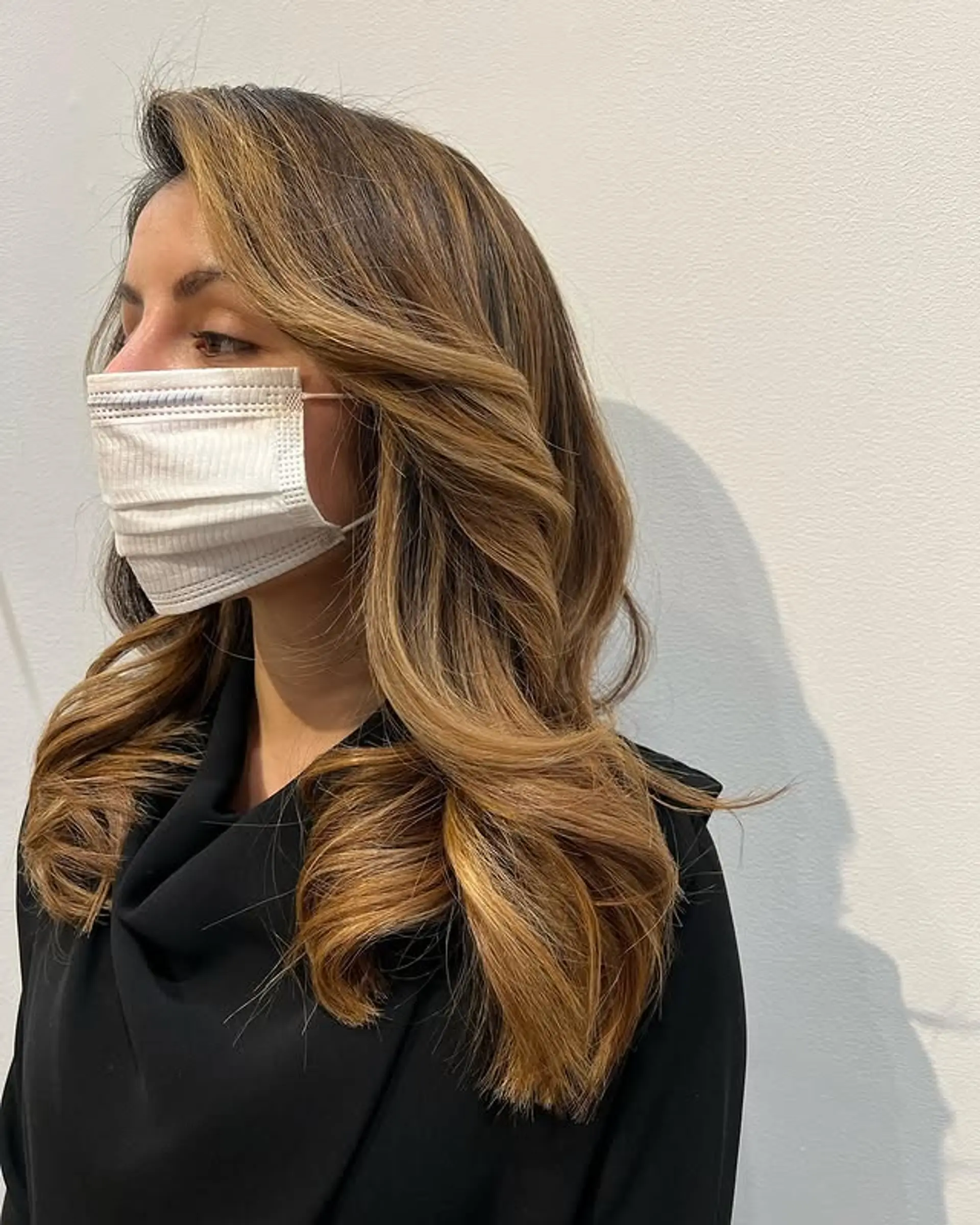 Long layered waves with face-framing and caramel highlights. 1