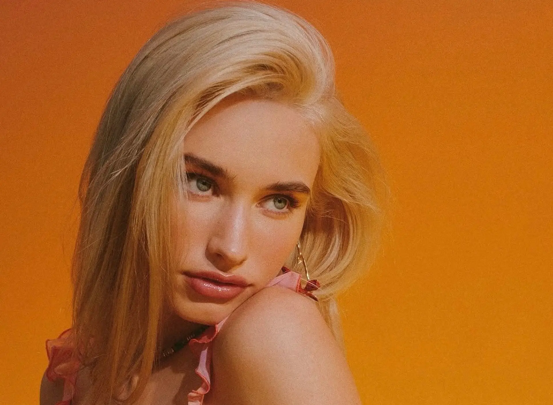 Voluminous platinum blonde hair styled with a deep side part and a smooth, soft finish. 1